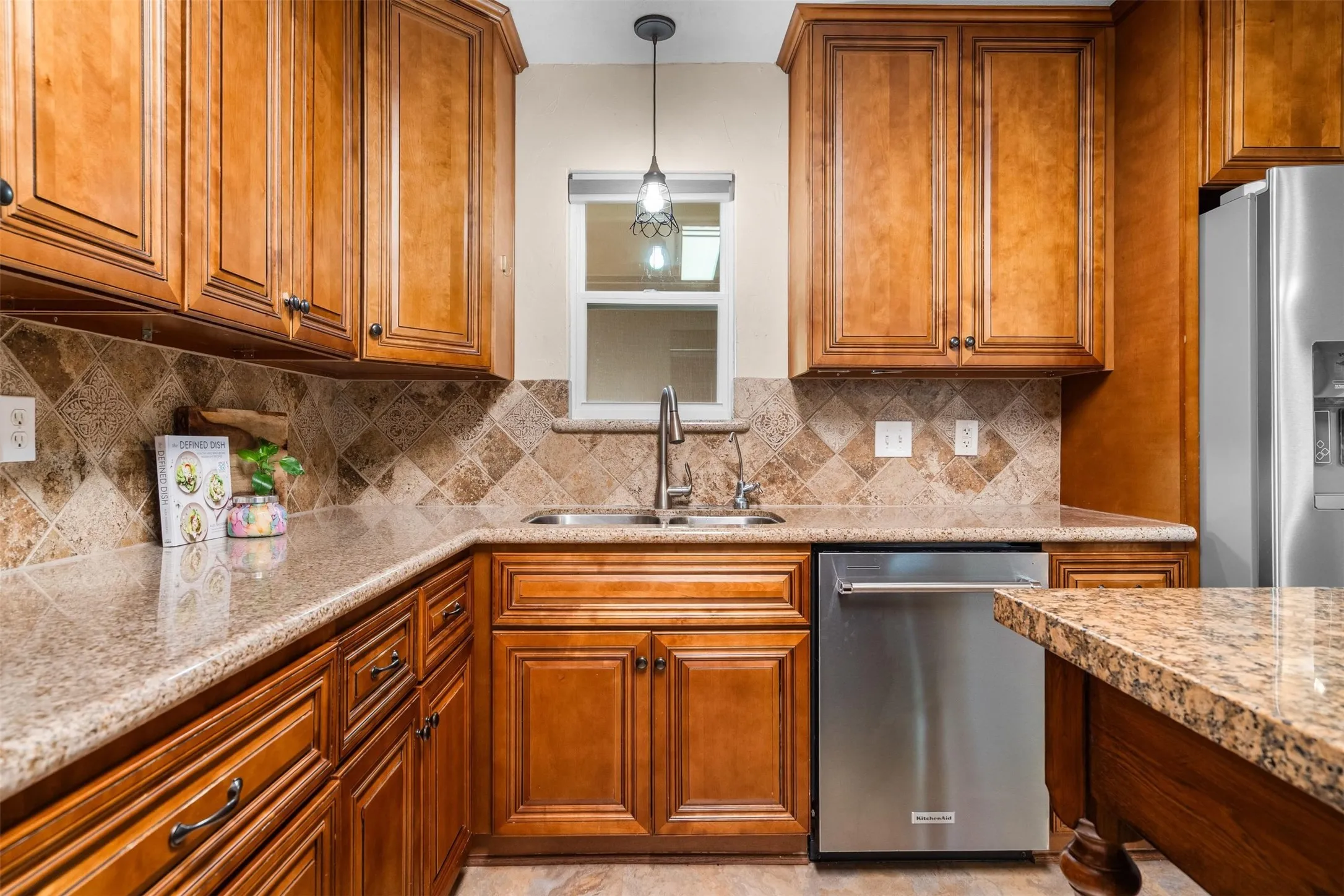 Rich wood cabinets and a tile backsplash.