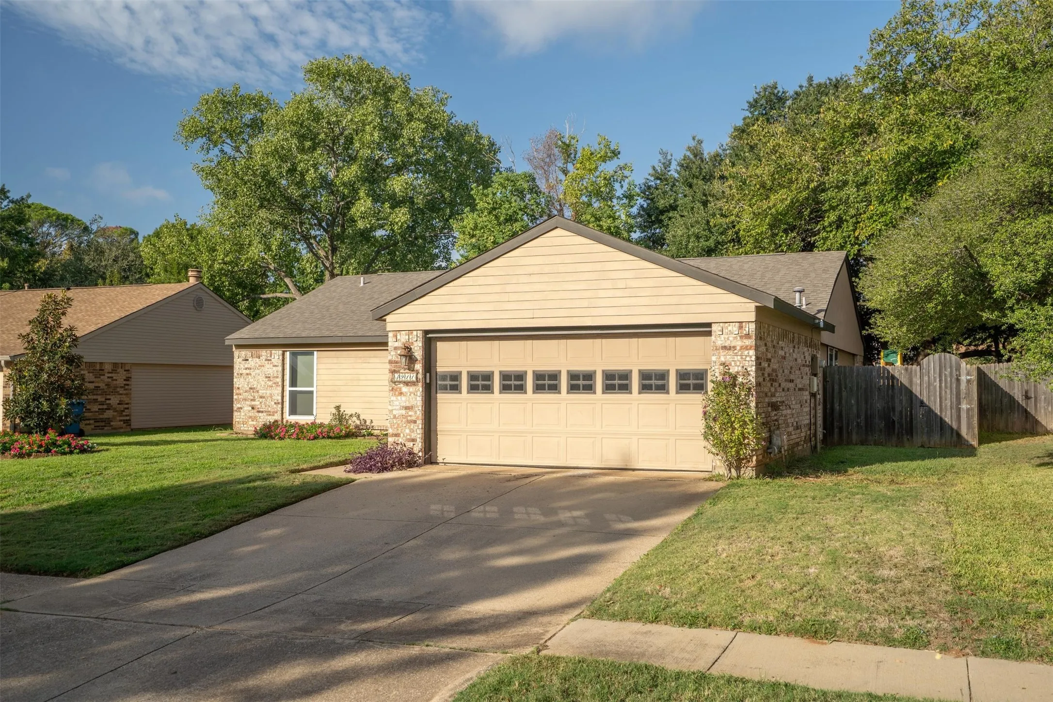 Two-car garage and a wide driveway.
