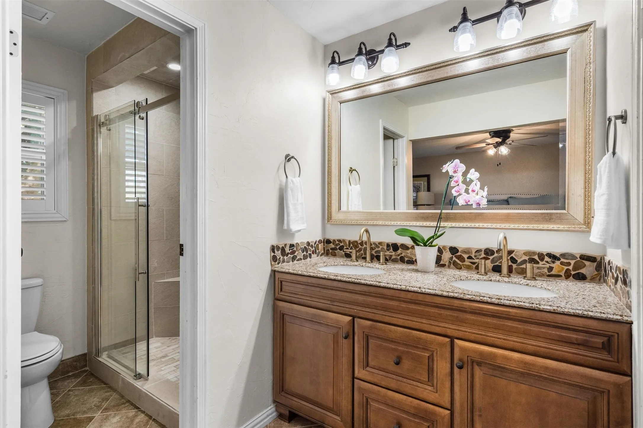 New tiled walk-in shower and a double granite vanity.