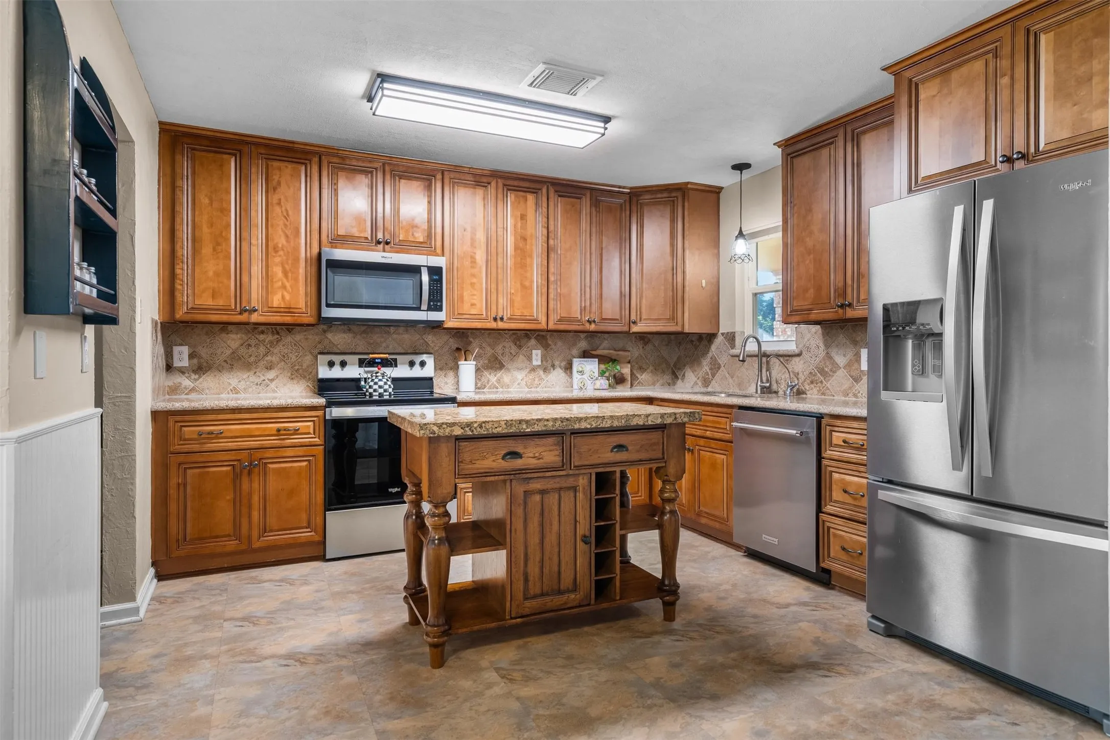 Kitchen with granite counters and stainless steel appliances.