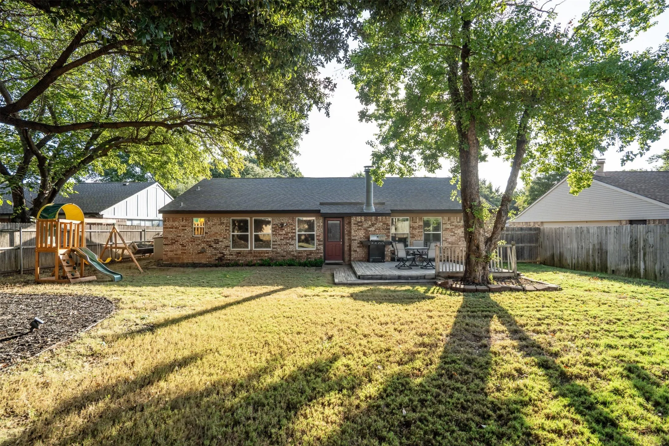 Shade trees cover the backyard.