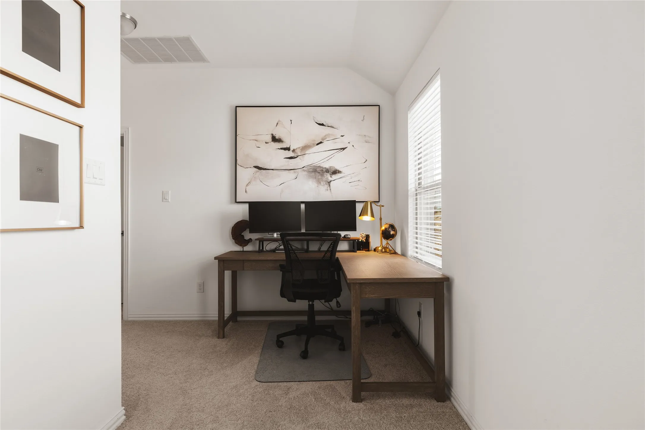 Neutral interior space featuring carpeting and a window with horizontal blinds