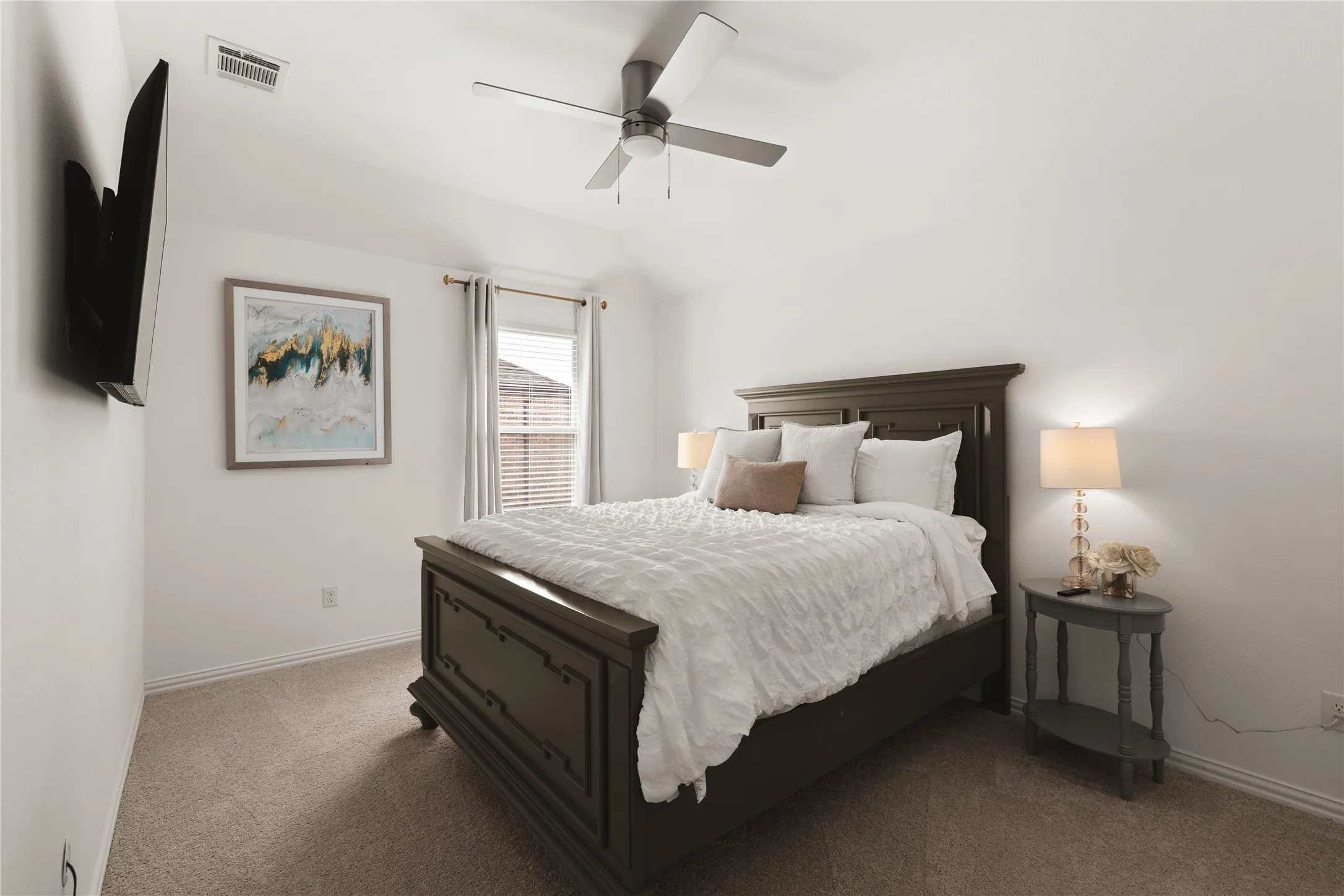 Bedroom featuring a high vaulted ceiling, neutral wall-to-wall carpeting, and a multi-blade ceiling fan with integrated lighting