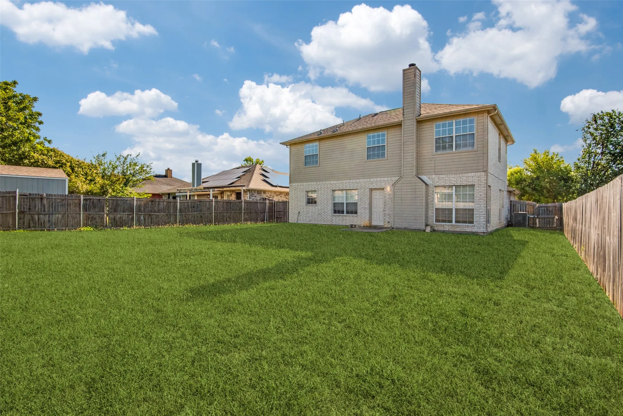 Rear view of property featuring a yard