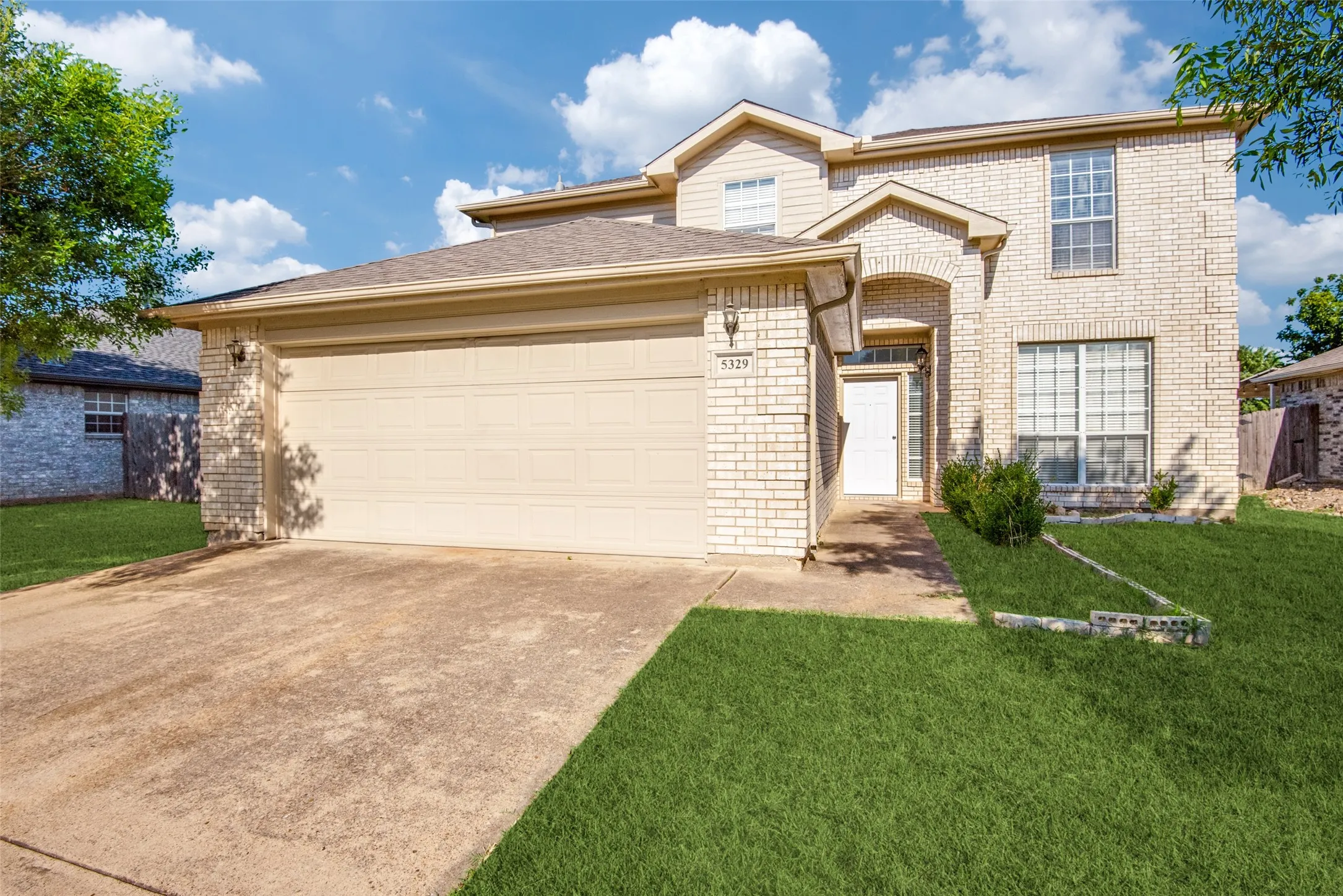 View of front of property with a garage and a front yard