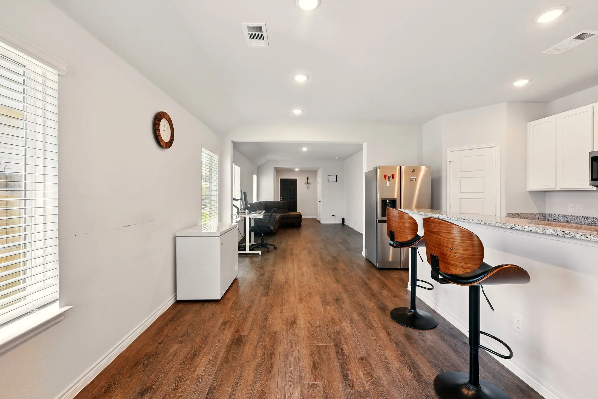 Expansive interior with wood-finish flooring and recessed lighting