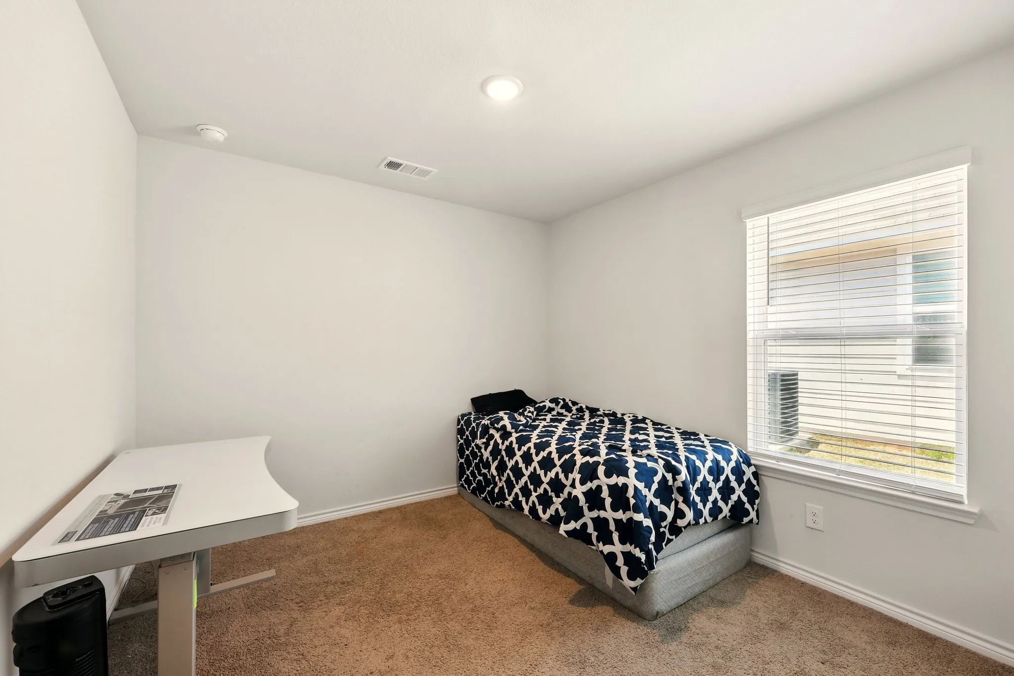 Neutral-toned walls complement the carpeted flooring
