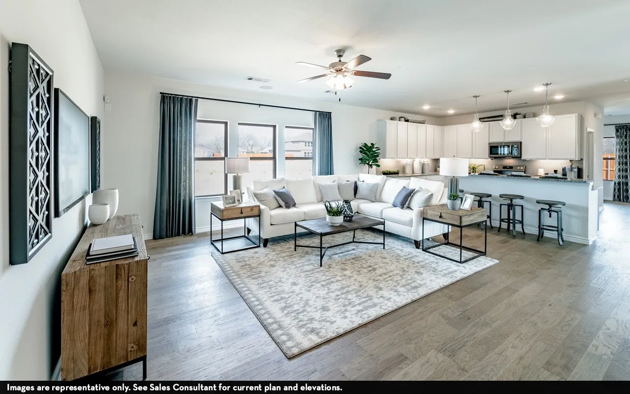 Open-concept living area featuring wood-finish flooring, recessed lighting, and a ceiling fan