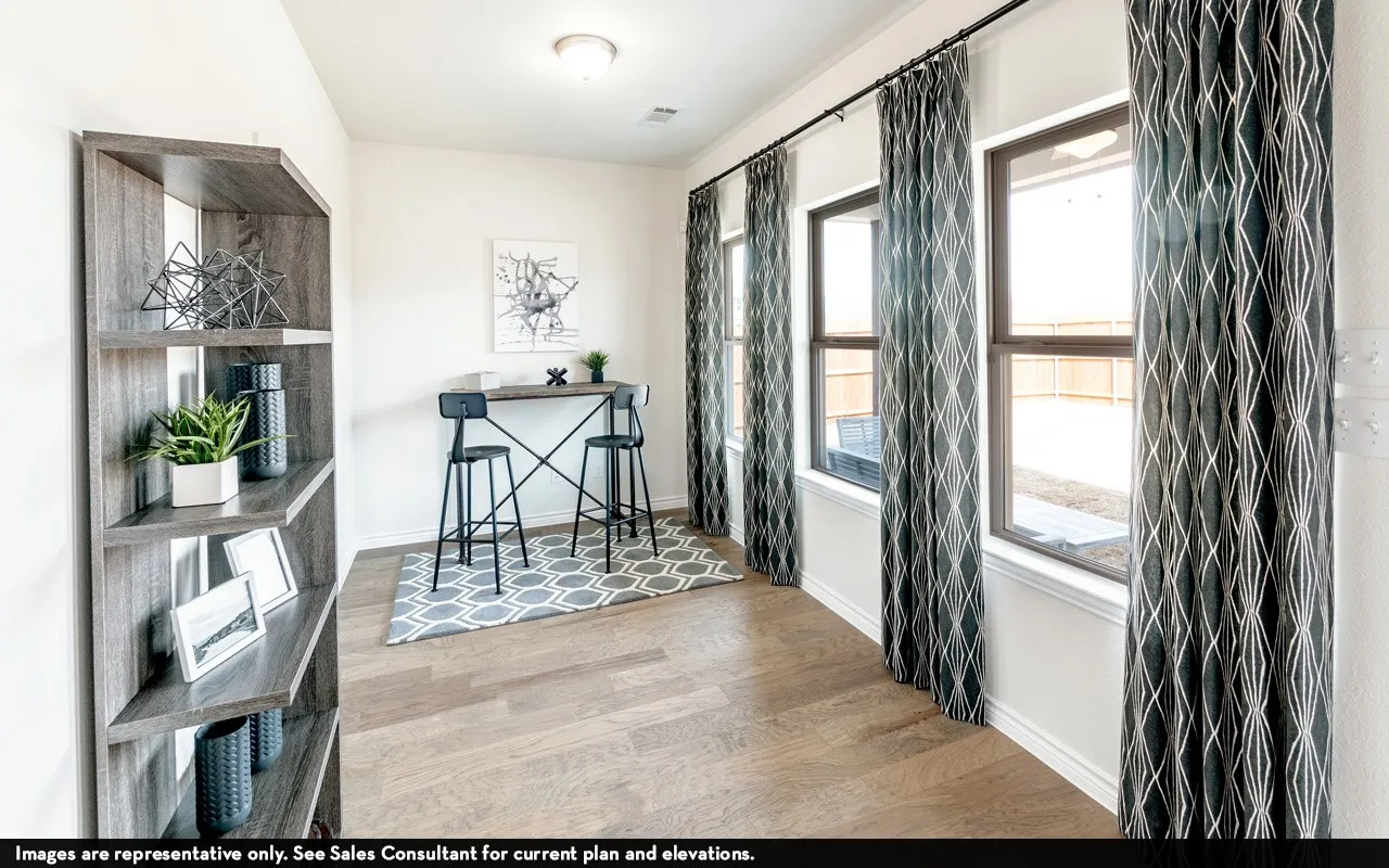 Wood-finish flooring with a built-in shelving unit, multiple windows, and a flush mount ceiling light