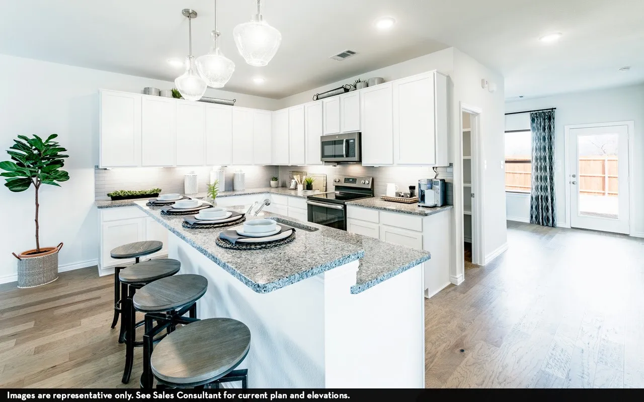 White cabinetry kitchen featuring a large island with a stone counter, stainless steel appliances, and wood-finish flooring