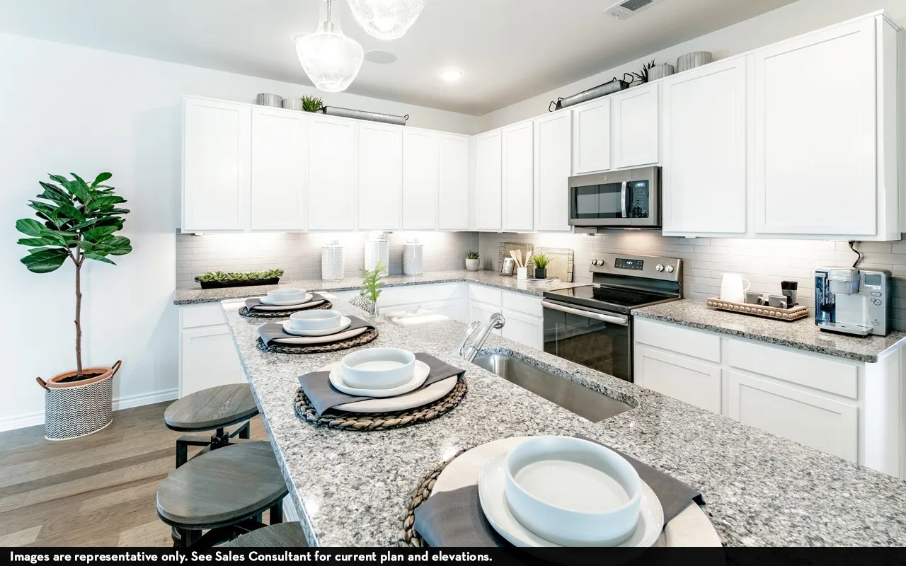 White shaker cabinetry, stainless steel appliances, granite countertops, subway tile backsplash, and wood-finish flooring