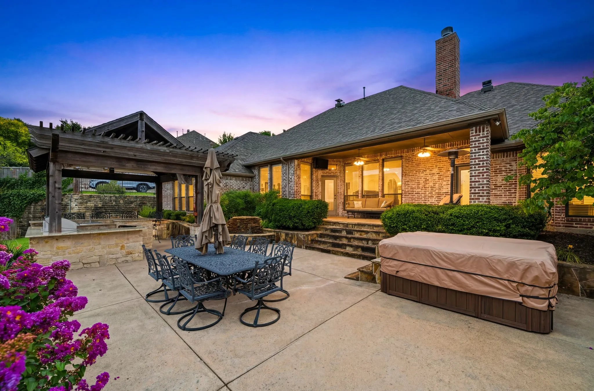 Spacious patio with concrete slab flooring and stone retaining walls