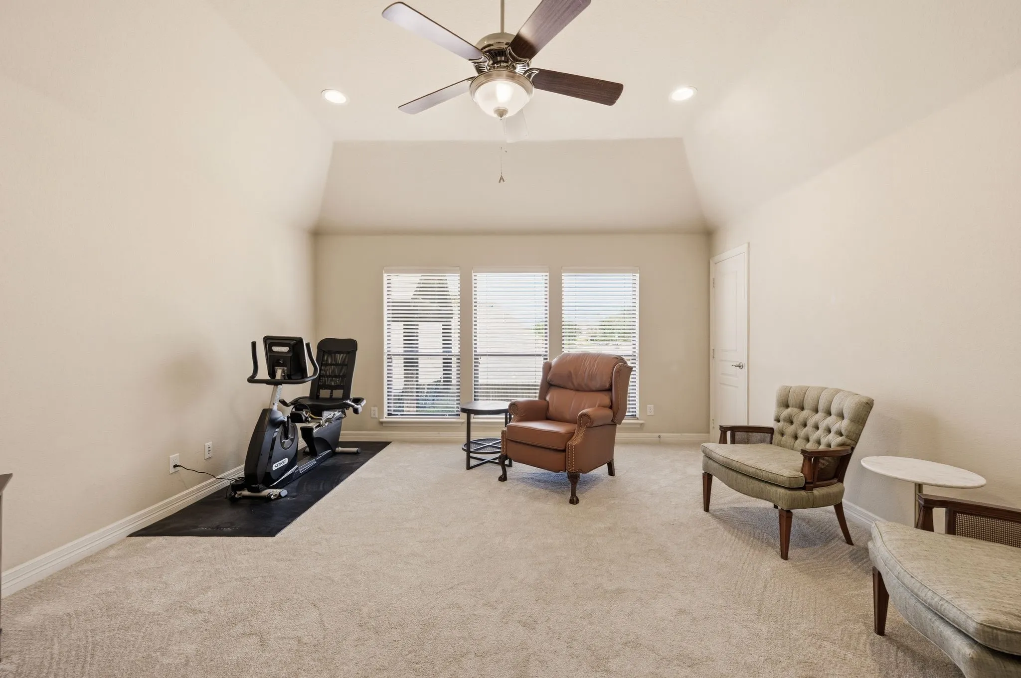 Vaulted ceiling, carpeting, recessed lighting, central ceiling fan, and triple windows