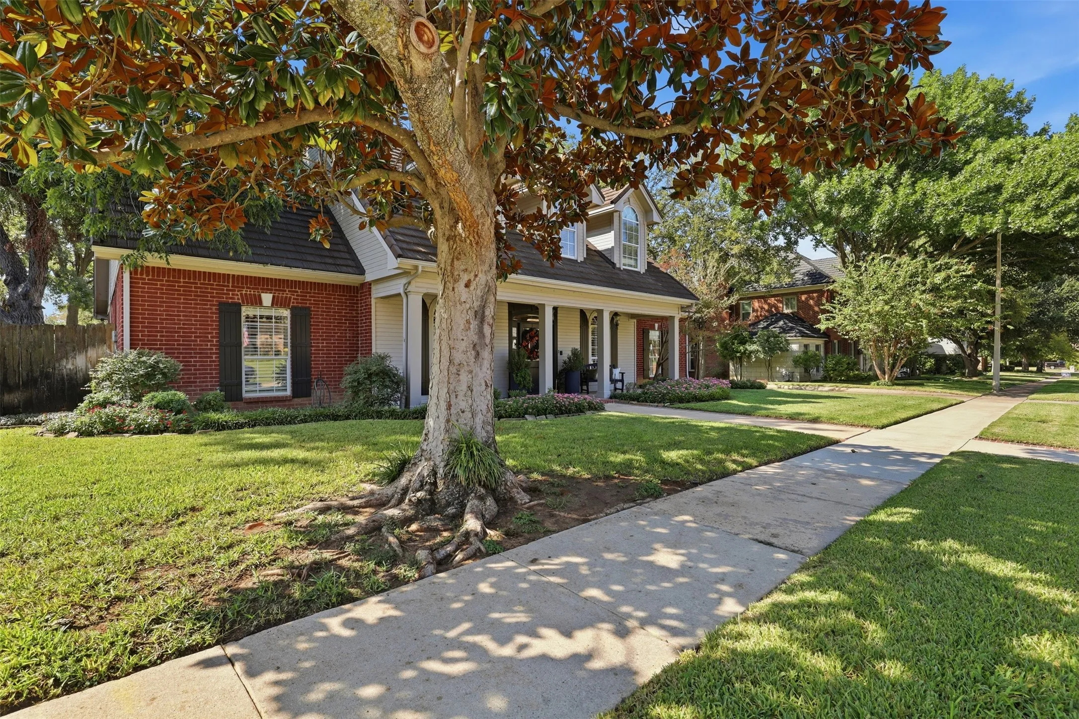 Enchanted Lake Estates has sidewalks & mature trees on this cul de sac lot