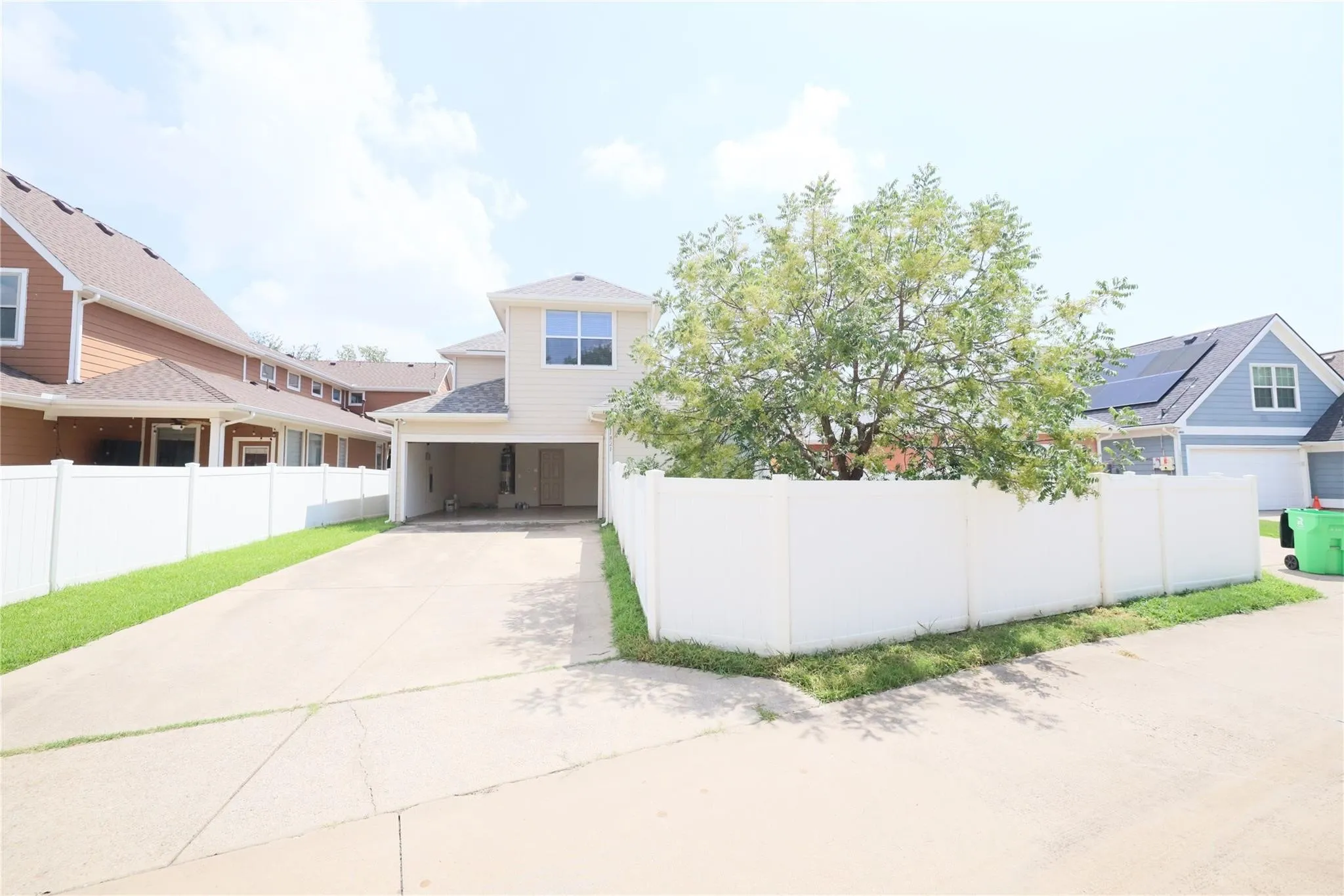 Paved driveway leading to a covered carport
