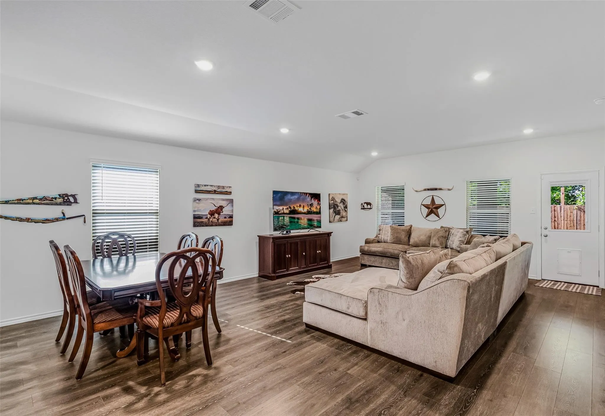 Living room featuring vaulted ceiling and dark hardwood / wood-style flooring
