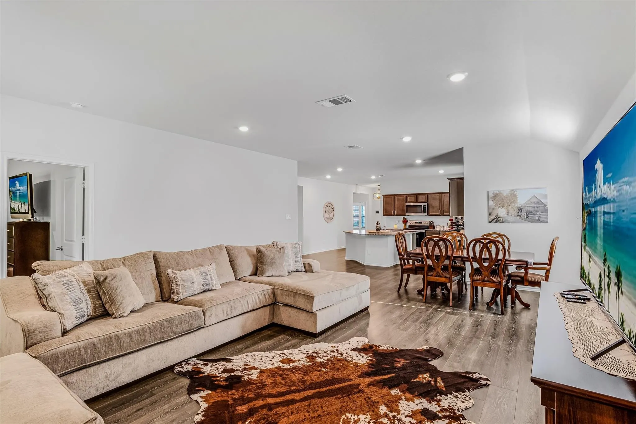 Living room with vaulted ceiling and light wood-type flooring