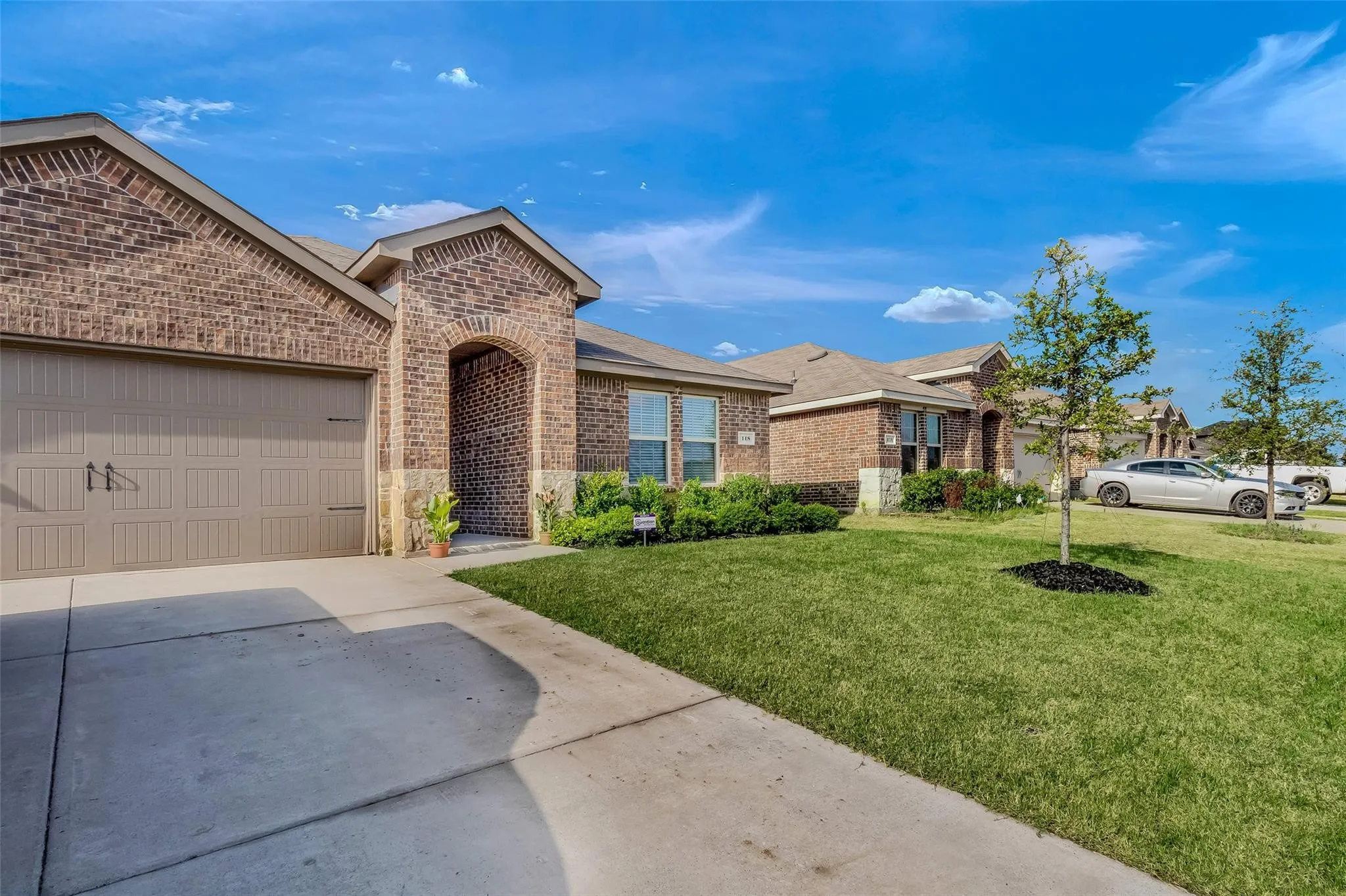 View of front of house with a front yard and a garage