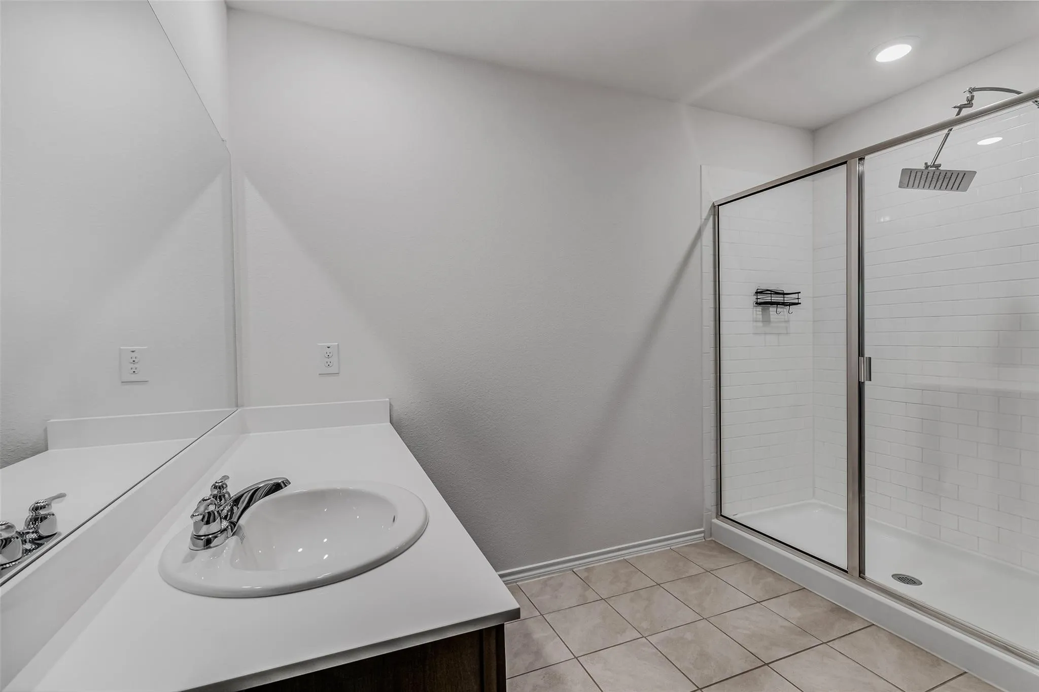Bathroom featuring vanity, an enclosed shower, and tile patterned floors