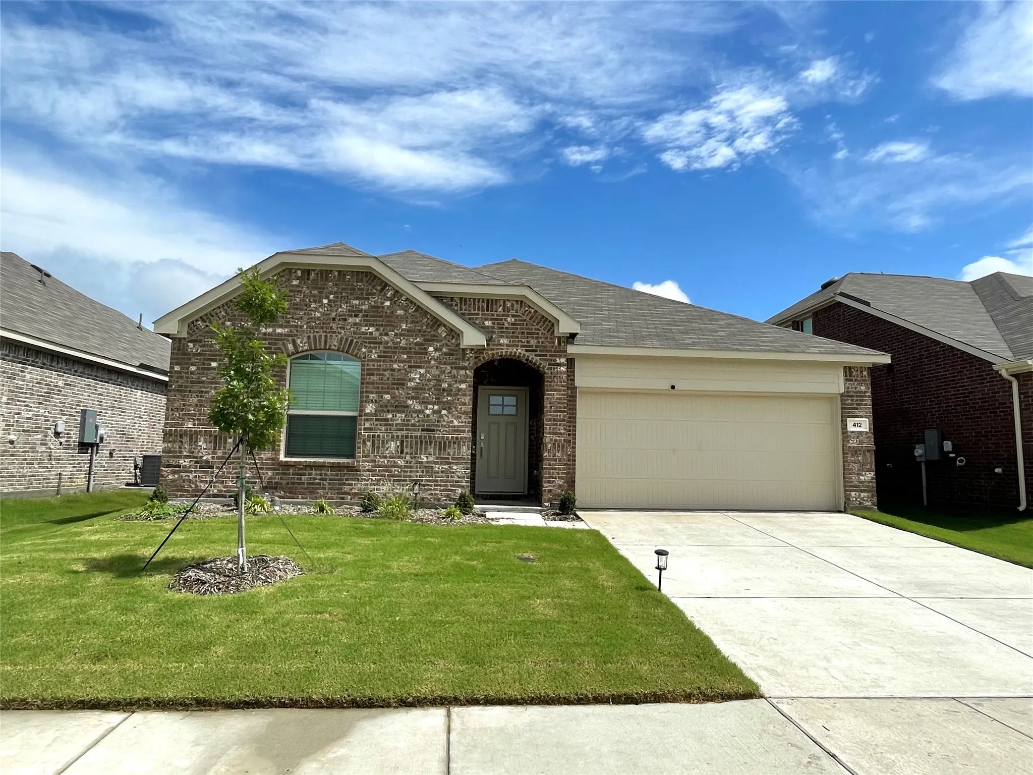 View of front of home featuring a garage and a front yard