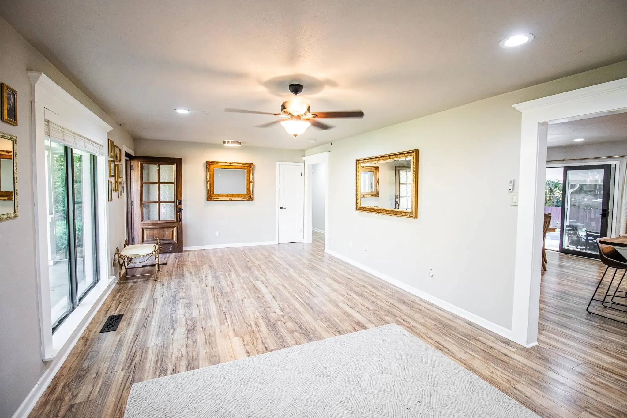 Interior space featuring wood-finish flooring, recessed lighting, a multi-blade ceiling fan, and multi-pane glass-panel door