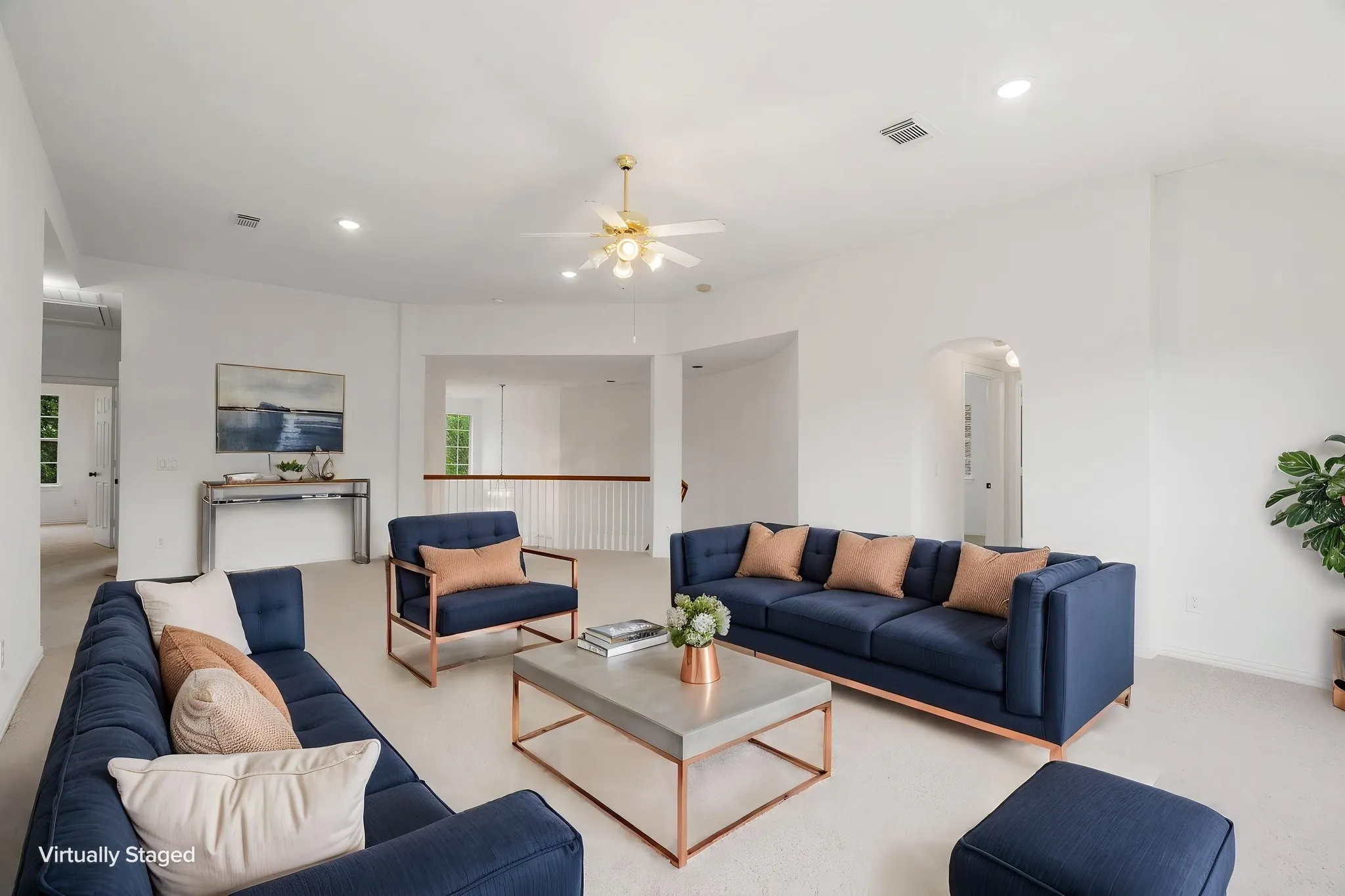 Vaulted ceiling, ceiling fan, recessed lighting, white walls, and an arched entryway