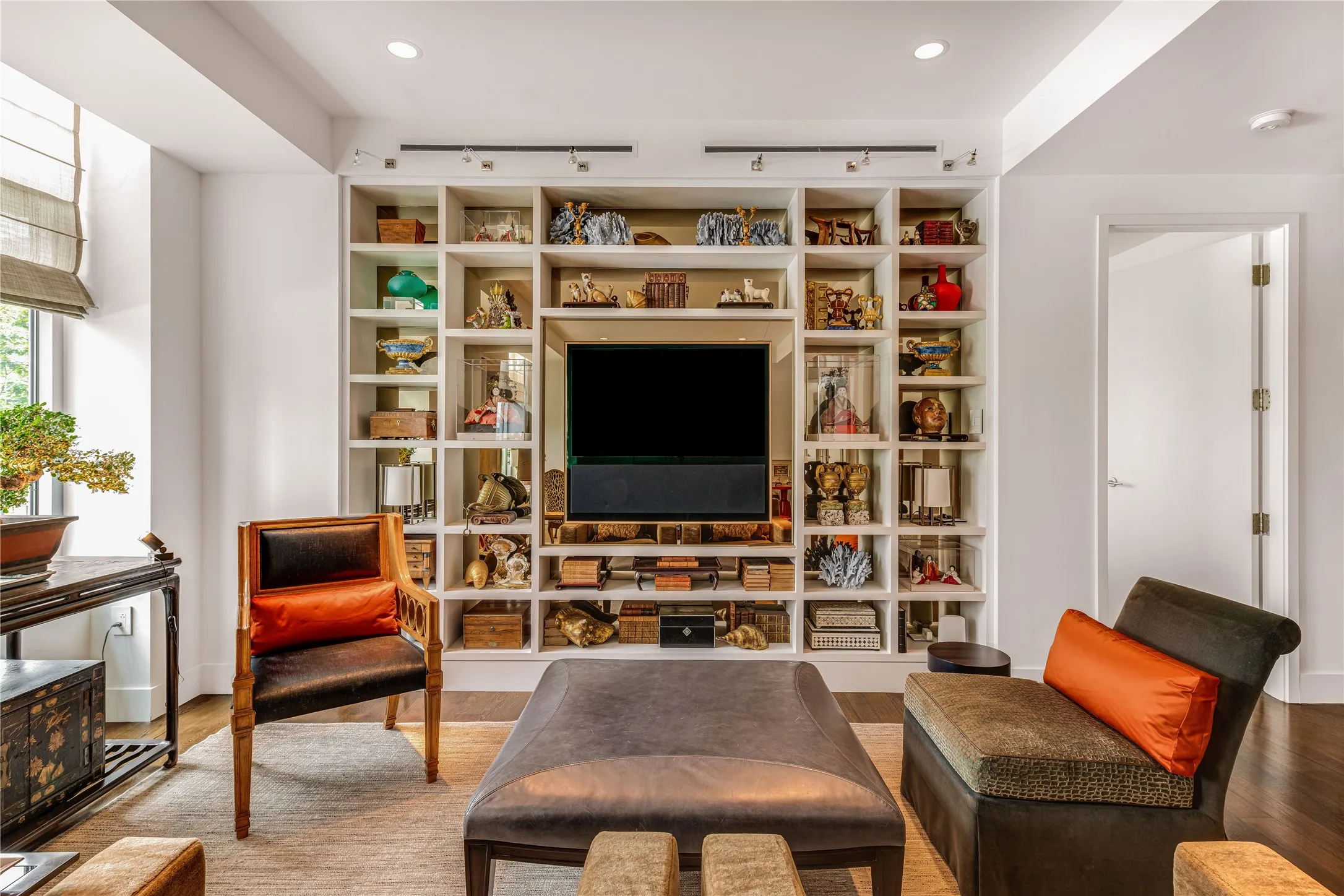 Built-in TV and library shelves in the living area.