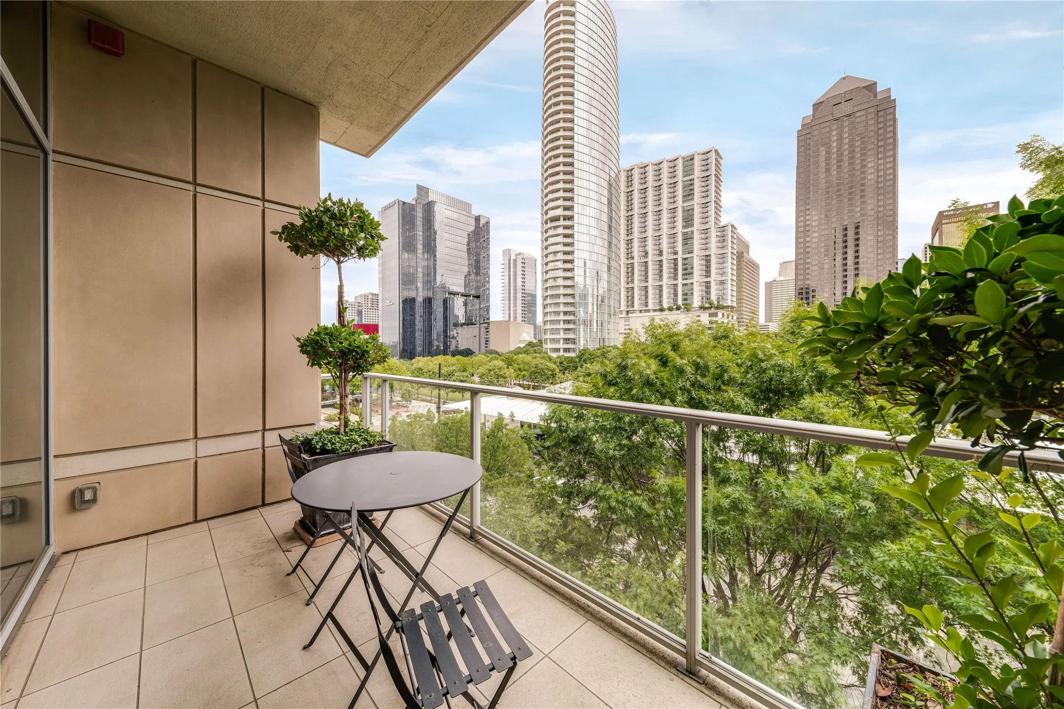 Covered balcony with park and downtown views.