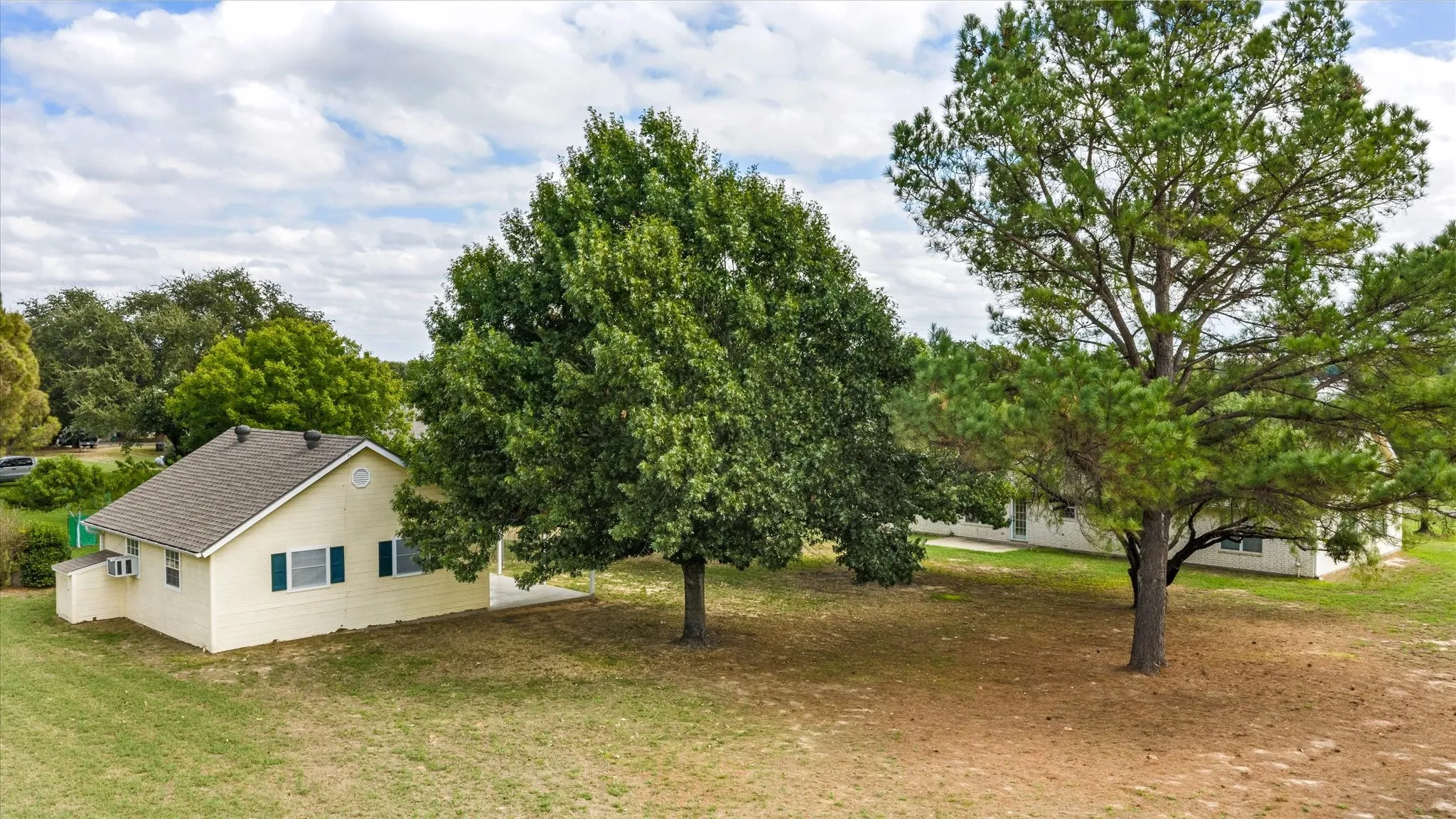 Back yard with out building and plenty of mature shade trees.