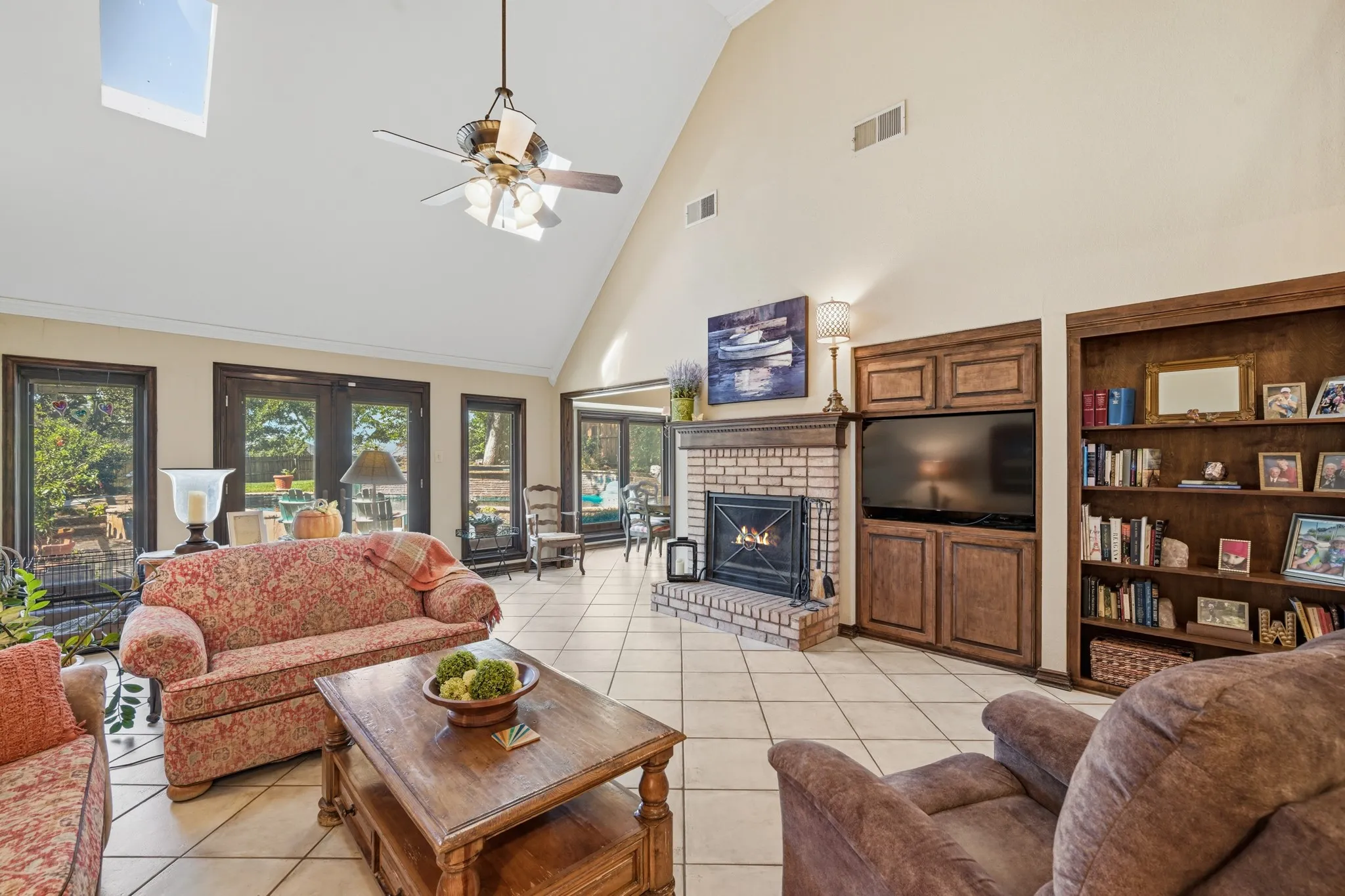Living room provides a view of the backyard. And features built in shelving.
