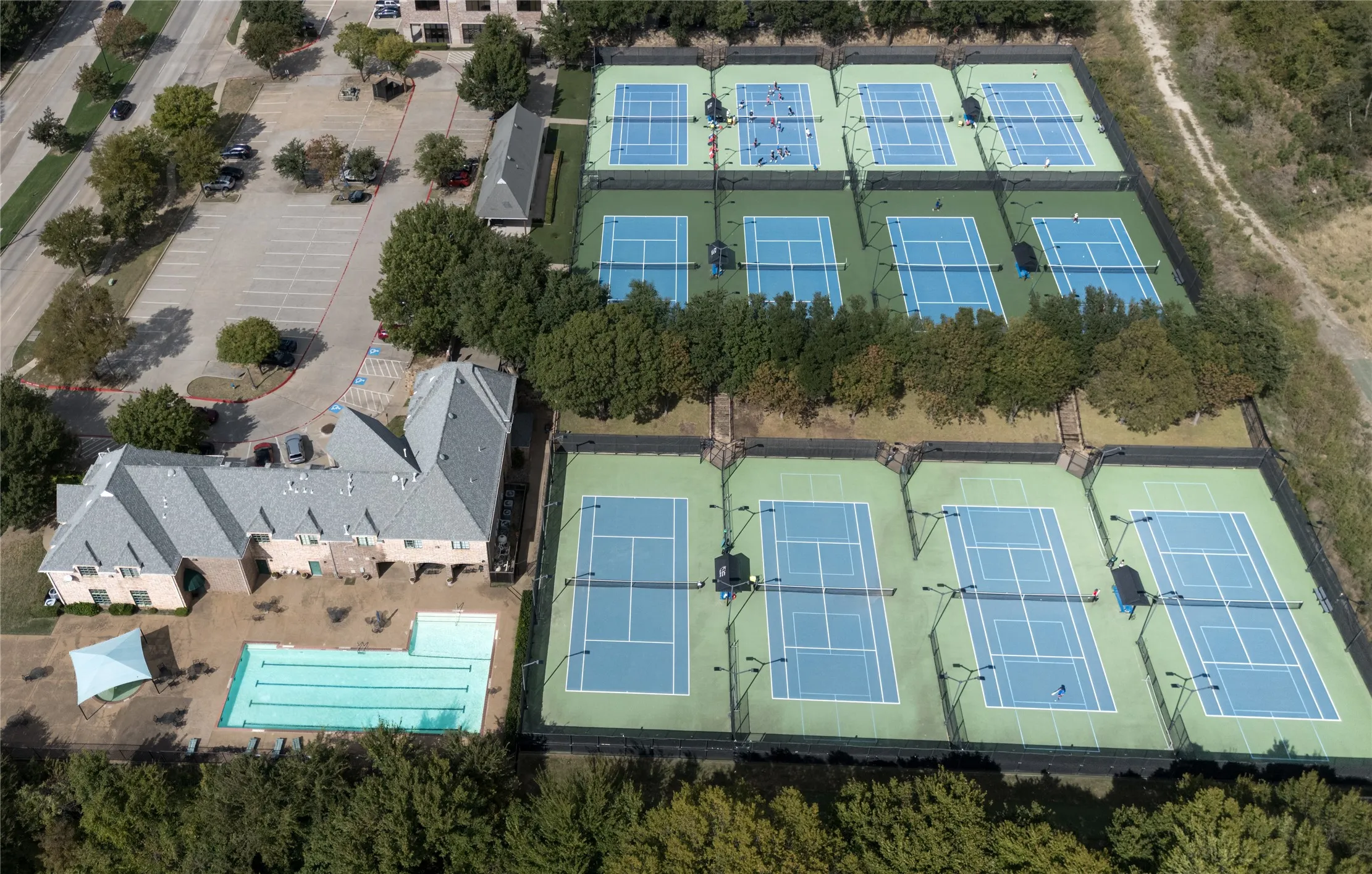 Eight outdoor tennis courts, swimming pool, and paved parking area