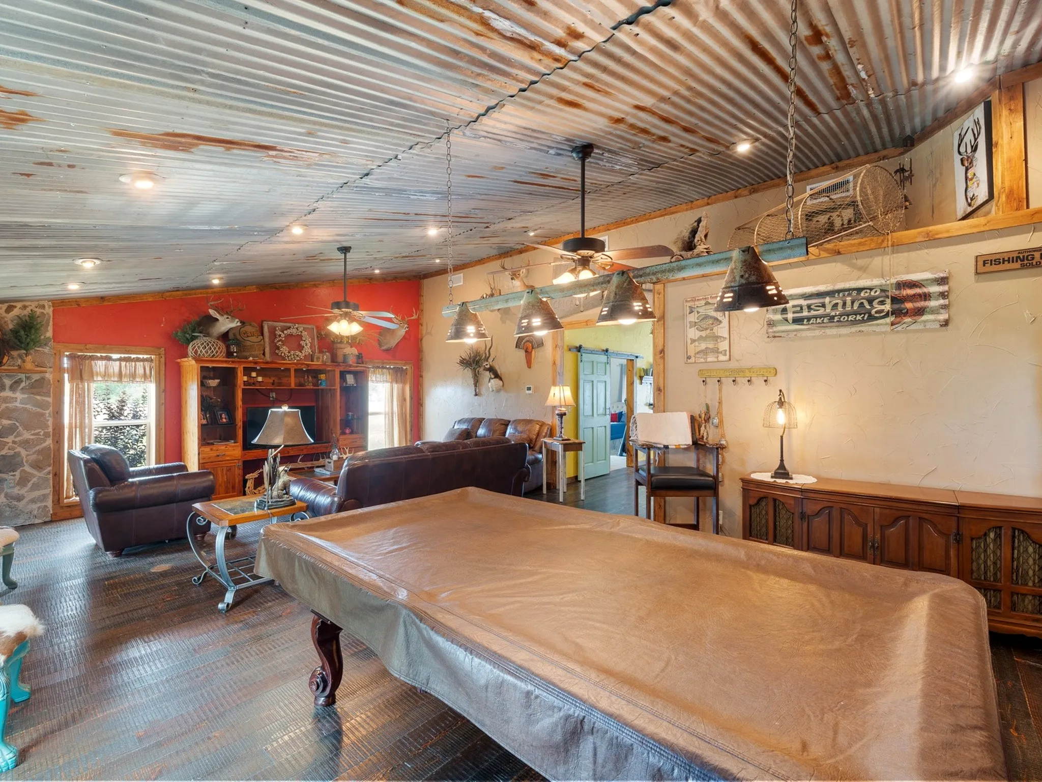 Corrugated metal ceiling with recessed lighting and ceiling fans