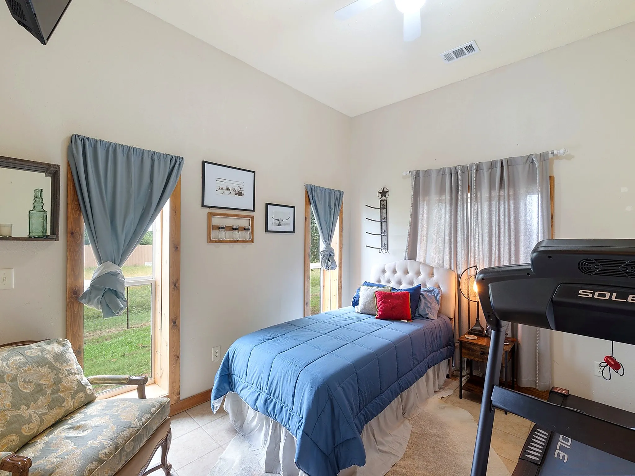 High ceilings, tile flooring, and dual windows with wood trim
