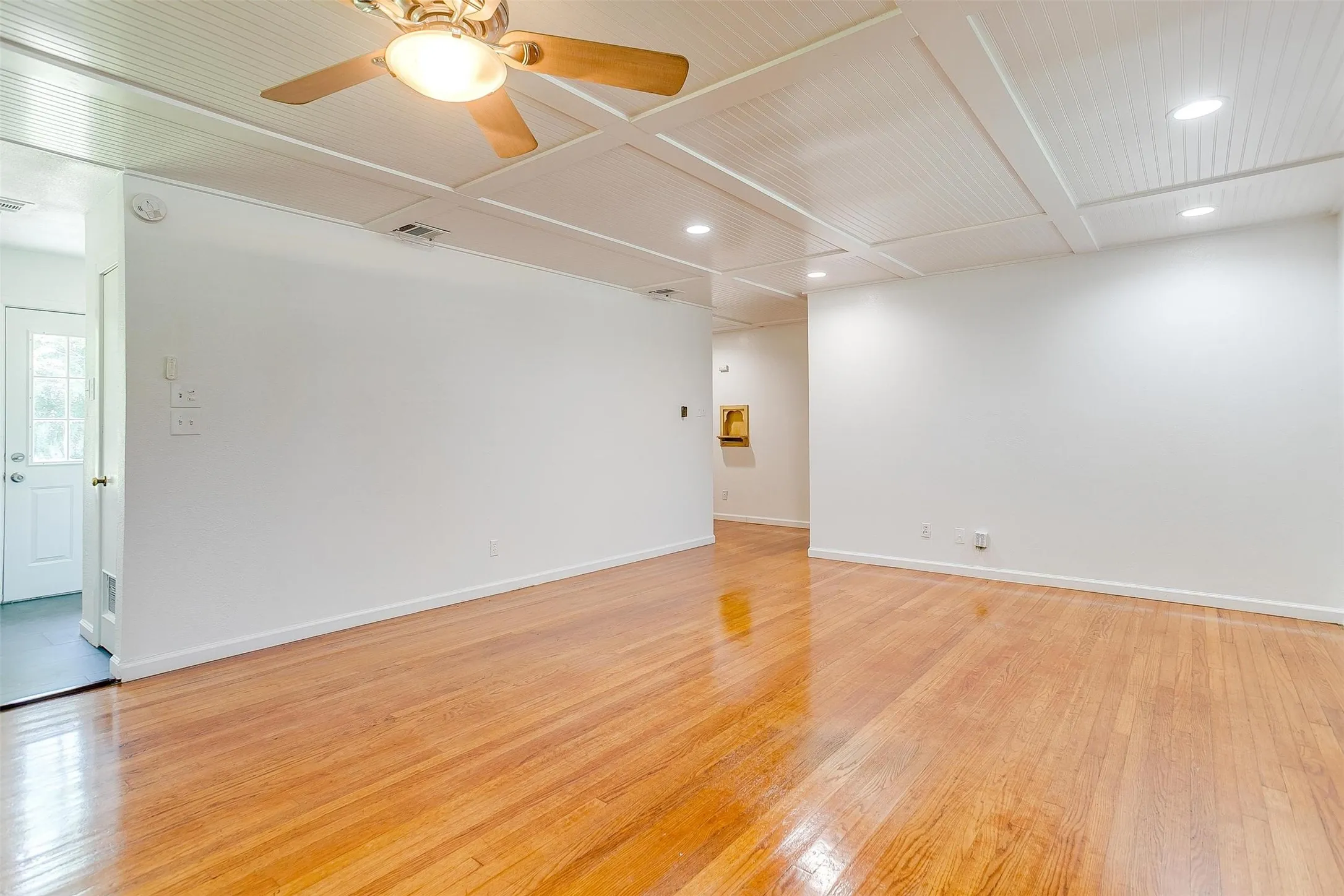 Spare room featuring ceiling fan and light wood-type flooring