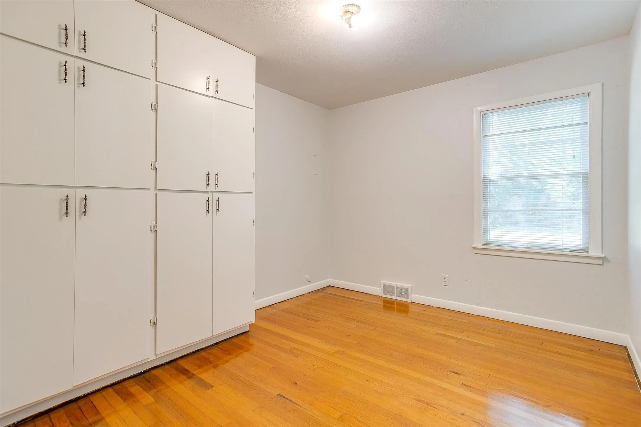 Unfurnished bedroom with light hardwood / wood-style floors