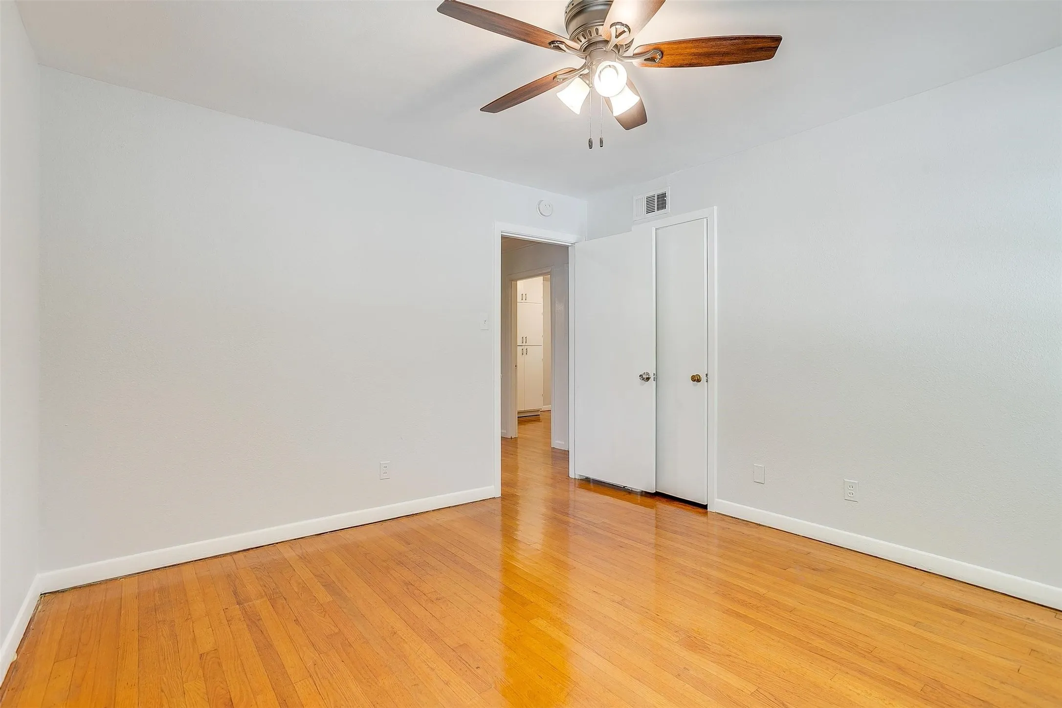 Spare room with ceiling fan and light hardwood / wood-style floors
