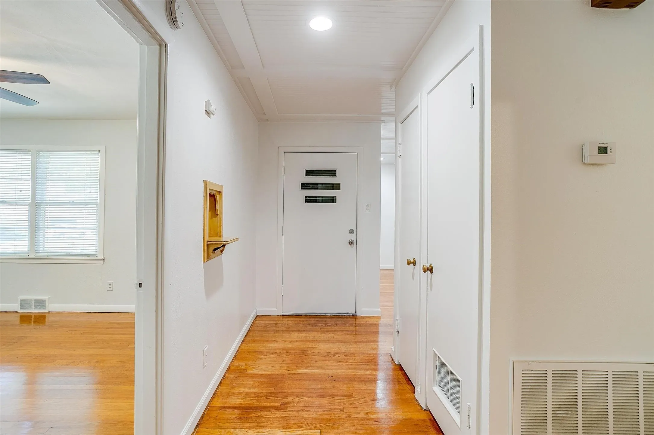 Corridor featuring light wood-type flooring