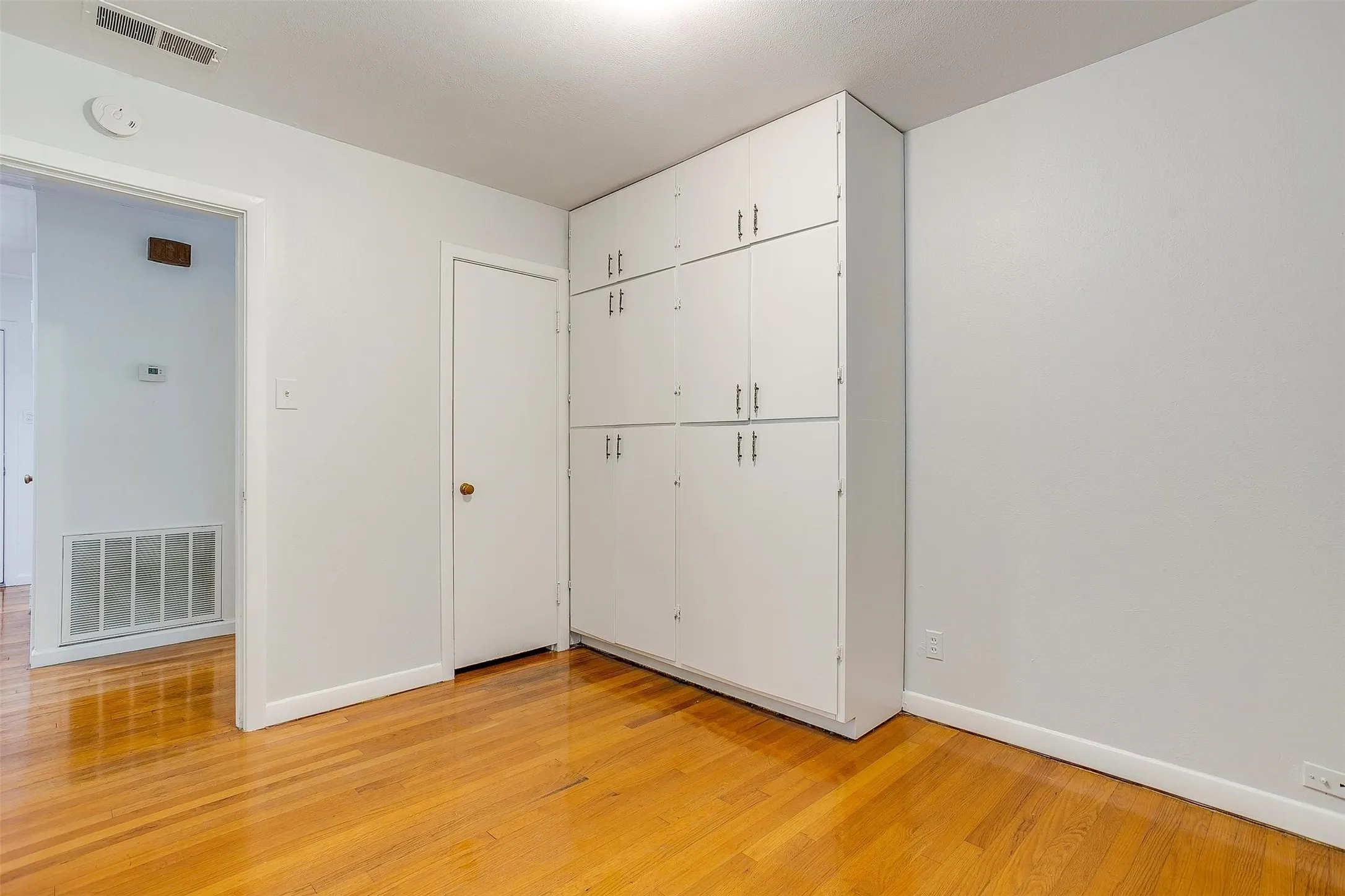 Unfurnished bedroom with a closet and light hardwood / wood-style floors