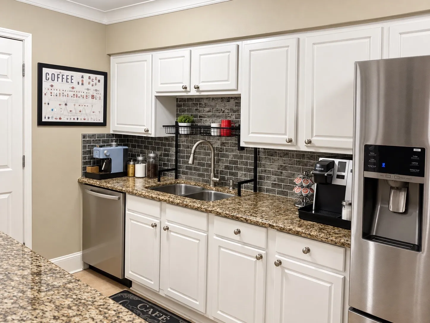 Kitchen featuring white shaker-style cabinetry, stone-patterned countertops, brick-style tile backsplash, stainless steel dishwasher, and stainless steel refrigerator with door-mounted dispenser