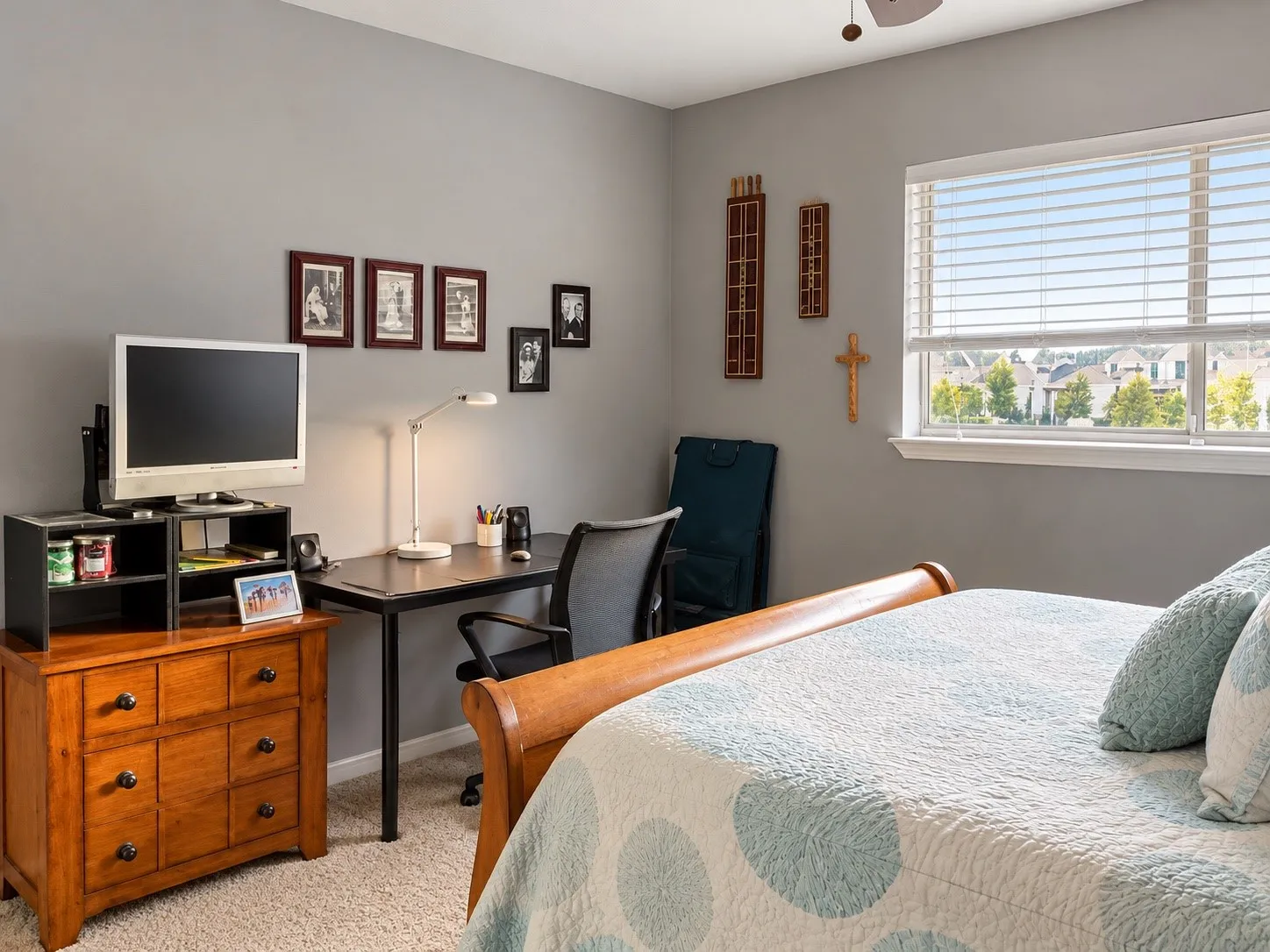 Neutral-toned interior featuring carpeted flooring and a multi-pane window with horizontal blinds