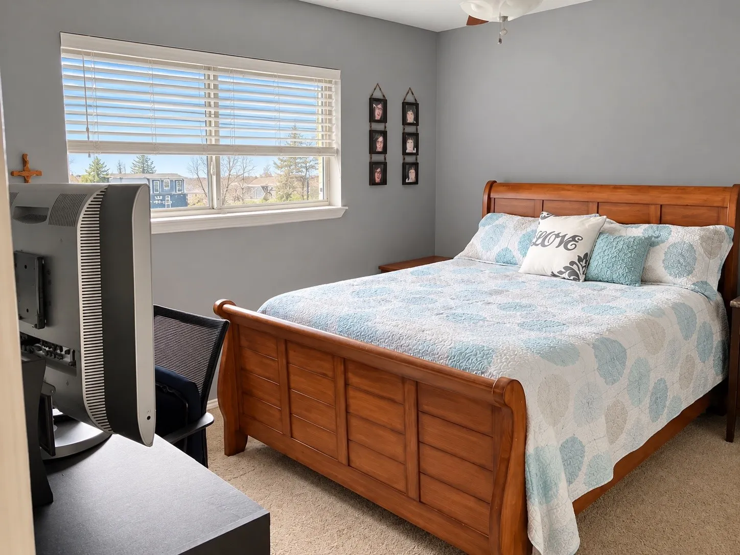 Neutral-toned room featuring a wide window with adjustable blinds and a flush-mount ceiling light fixture