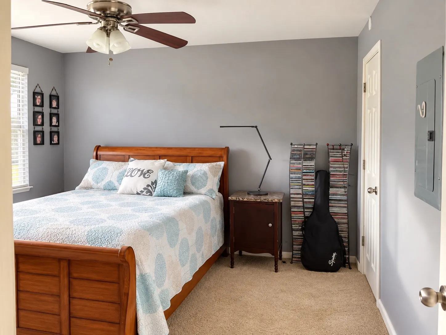 Neutral-toned walls featuring neutral carpeting, a dual-tone ceiling fan with integrated lighting, and a multi-panel door