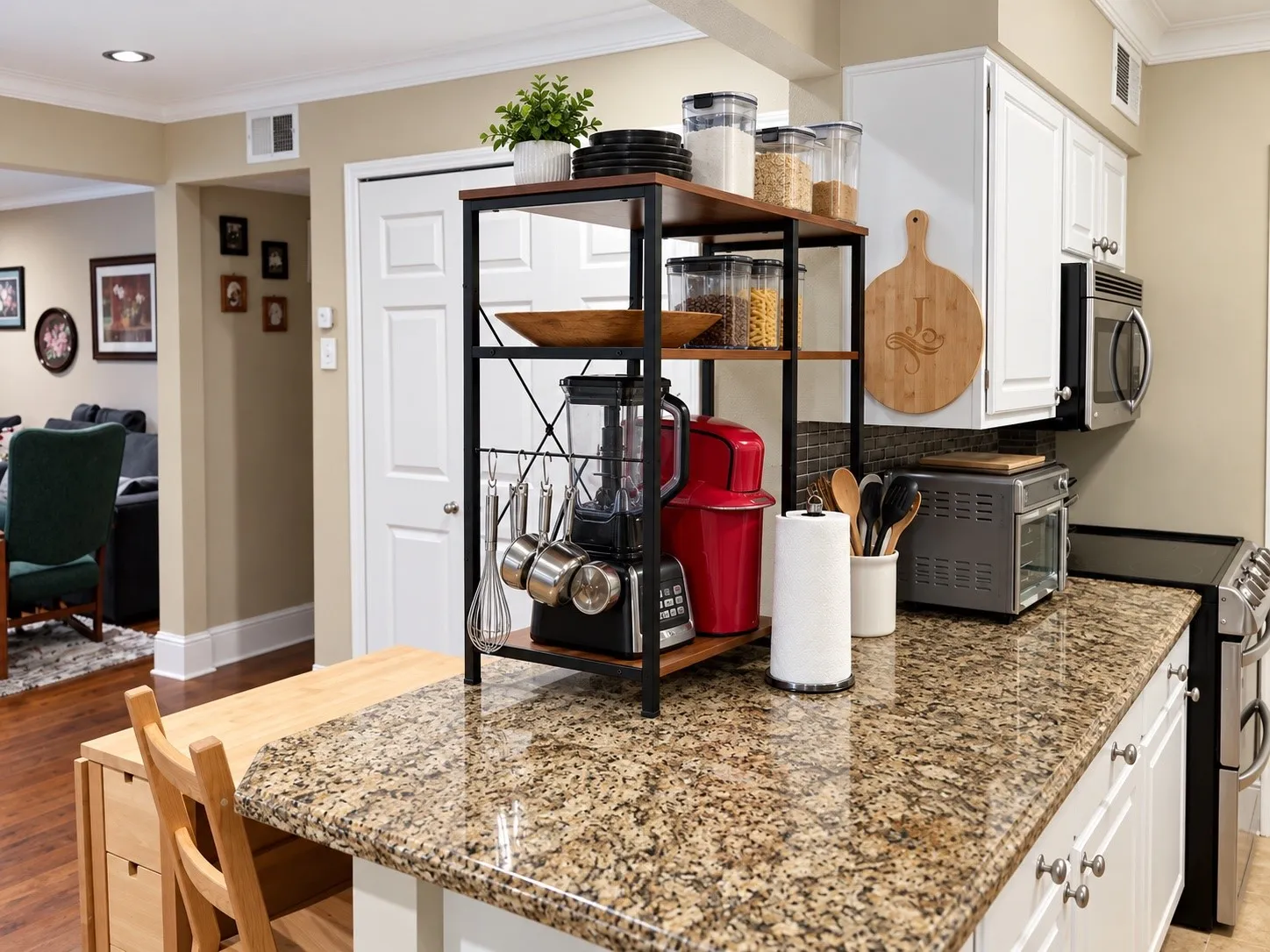 Stone-surface countertop, white cabinetry with silver-tone hardware, built-in microwave, and recessed ceiling lighting