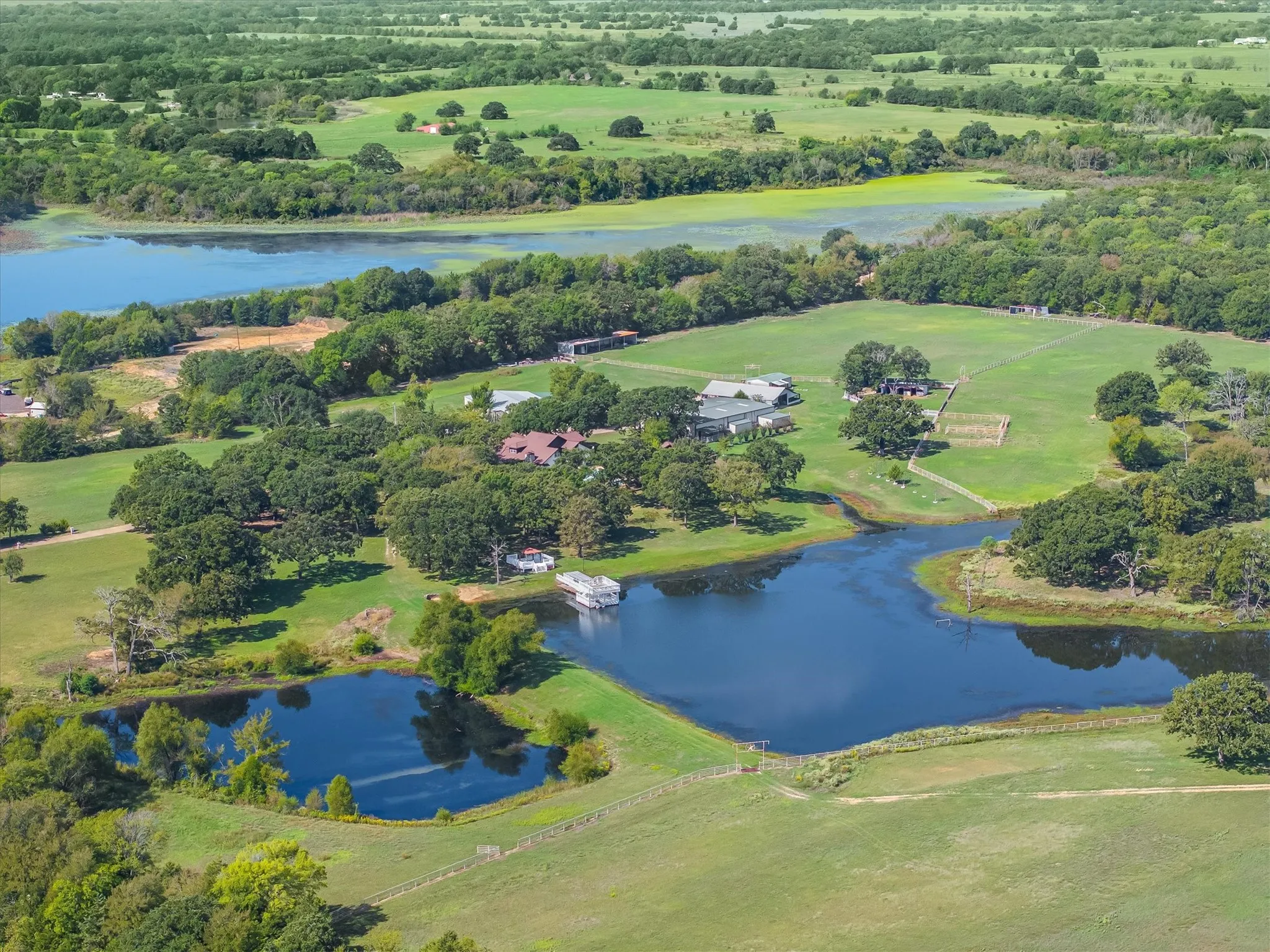 6164 SF home, 5 outbuildings including 8400 SF party barn, 4000 SF equipment barn, large pole barn for hay storage, large lake with beautiful fishing dock, lush Bermuda pastures.