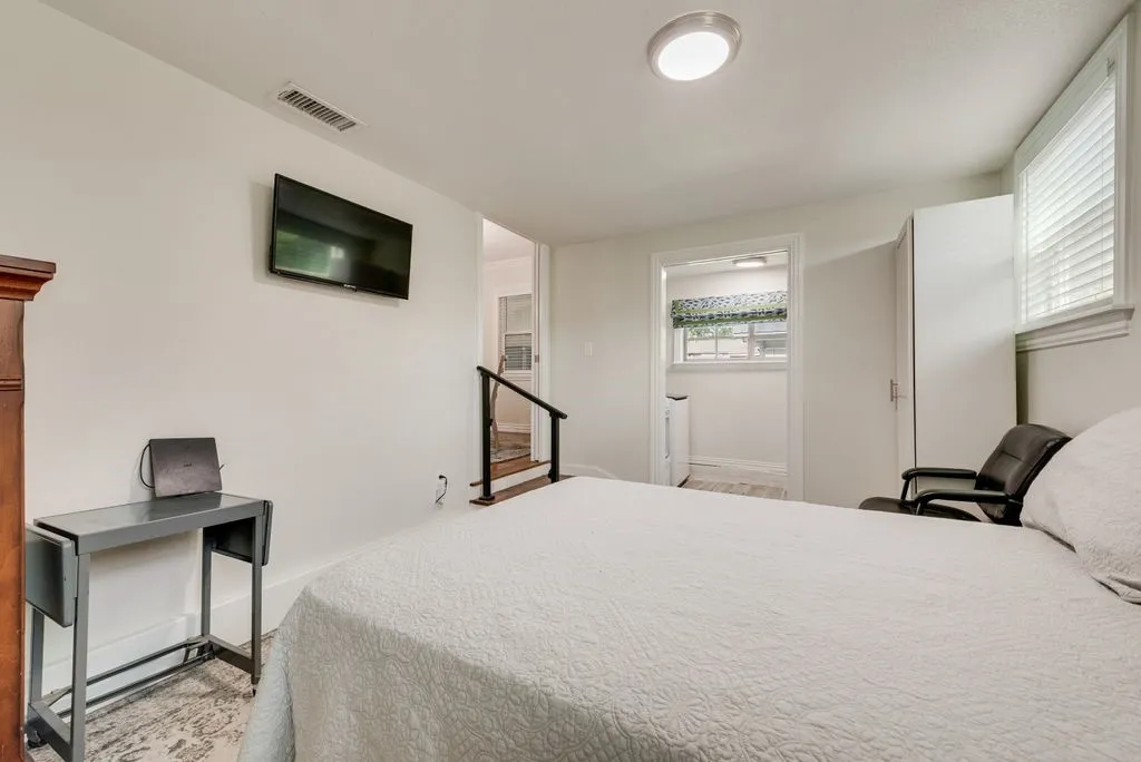 Neutral interior room featuring white walls, a flush-mount ceiling light, and window blinds
