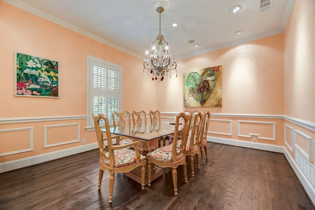 Room featuring wood-finish flooring, decorative wall molding, plantation shutters, recessed lighting, and a crystal chandelier