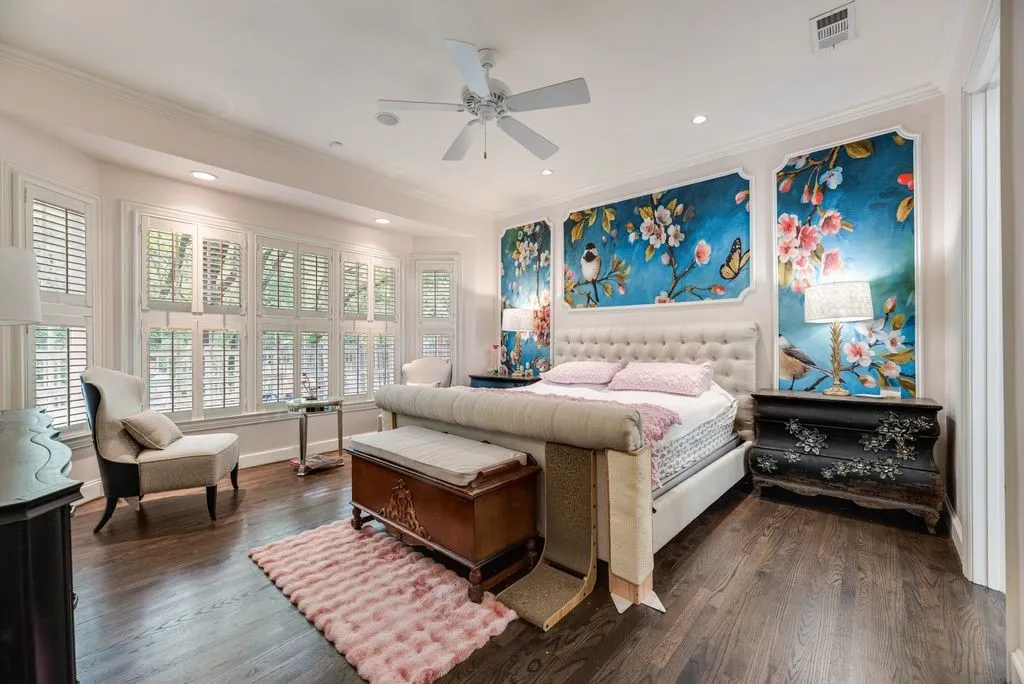 Dark wood-finish flooring, bay window with plantation shutters, custom framed wall murals, recessed lighting, and a ceiling fan