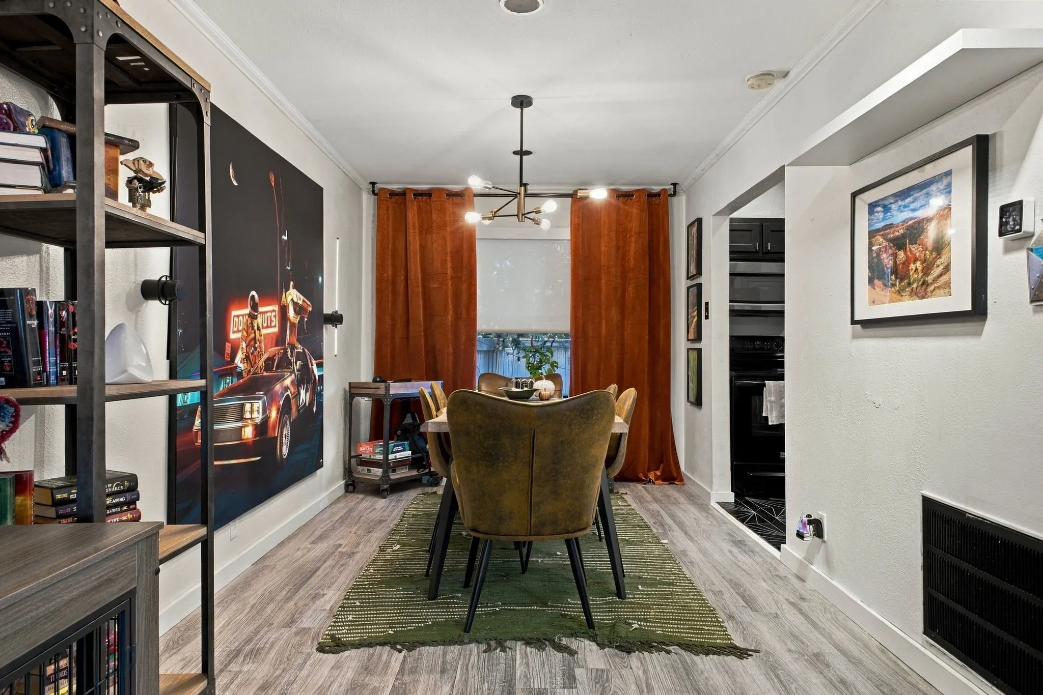 Wood-finish flooring, multi-arm metal chandelier, and recessed display shelving