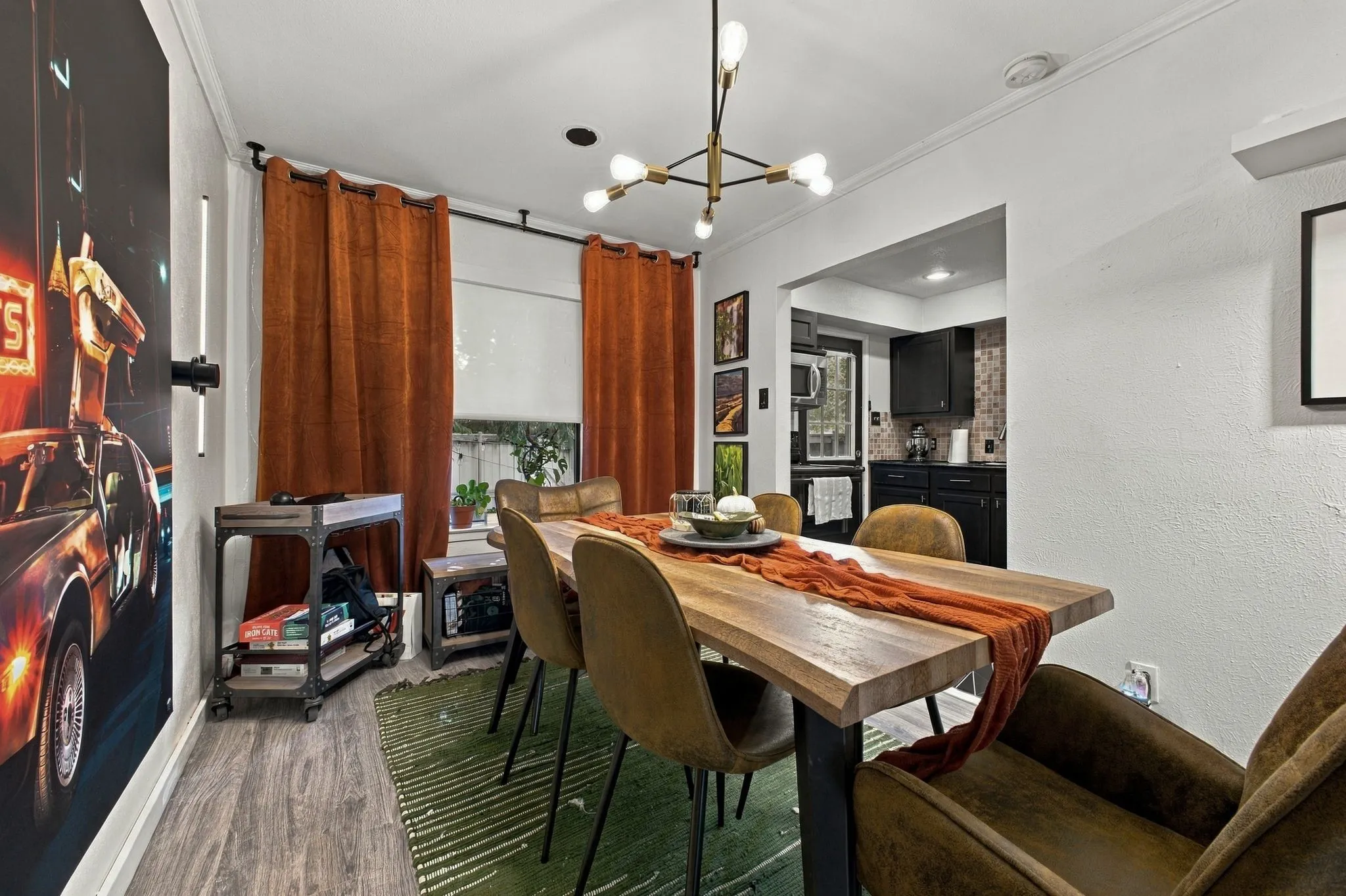 Modern multi-arm chandelier with gold-finish detailing and wood-finish flooring