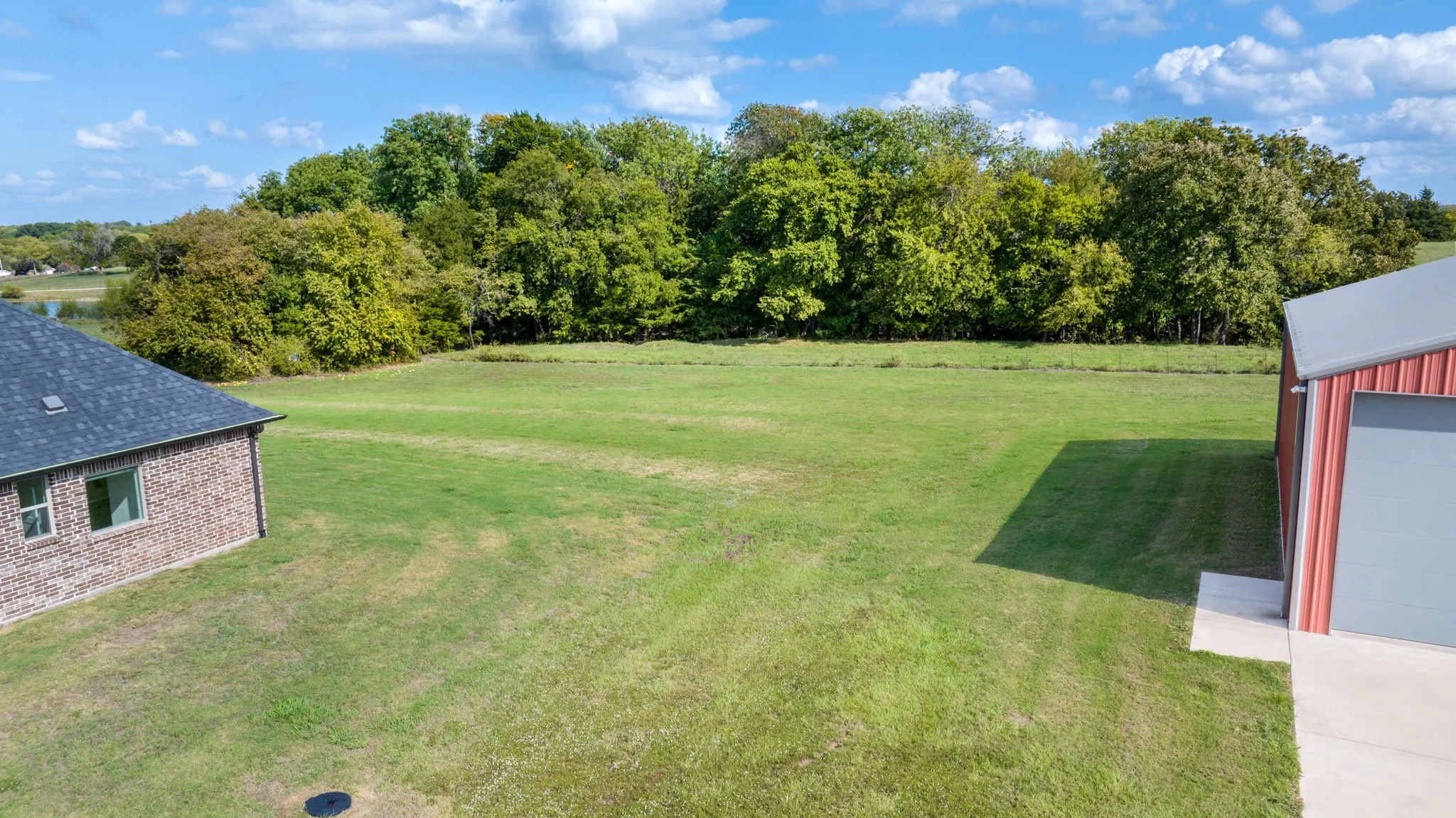 backyard with treeline views from covered patio